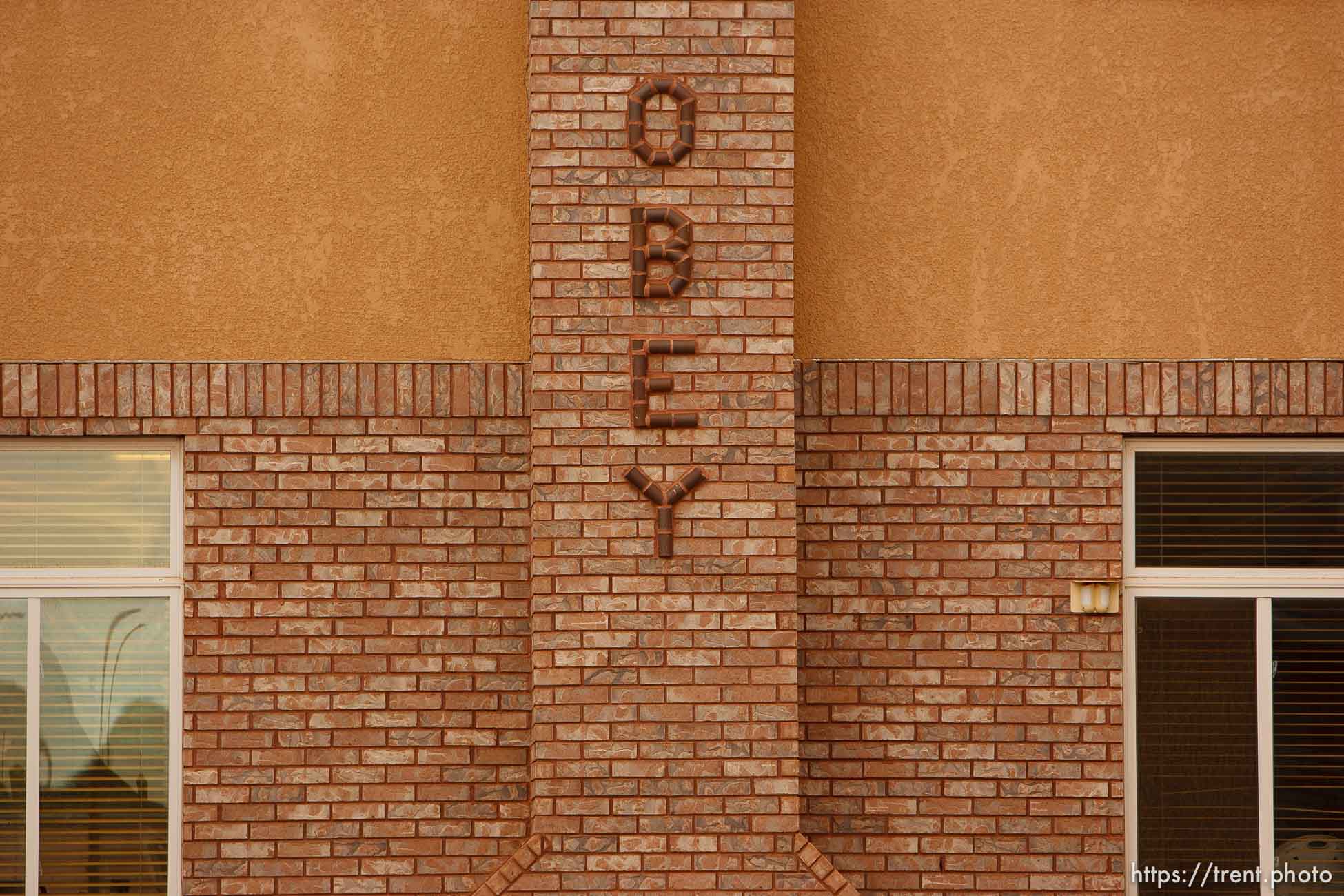 Hildale -, Wednesday August 12, 2009.
pray and obey on brick chimney at jeffs home