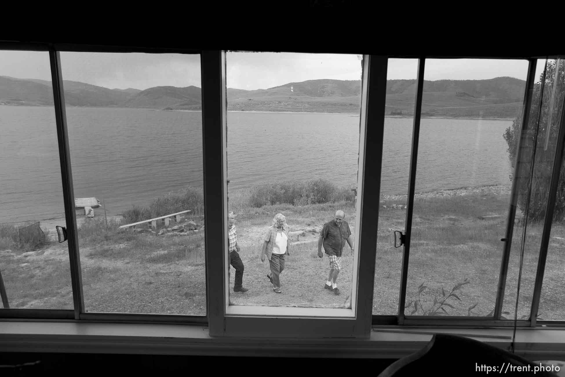 Scofield - People who have owned property and houses along the shores of the Scofield Reservoir for over 50 years are now being told by the federal government that they don't really own those places and must leave. The Mancina family could lose the cabin that's been in their family for over fifty years. Left to right, John Lamb, Judy Mancina Lamb, Paul Mancina, Thursday, September 3 2009.