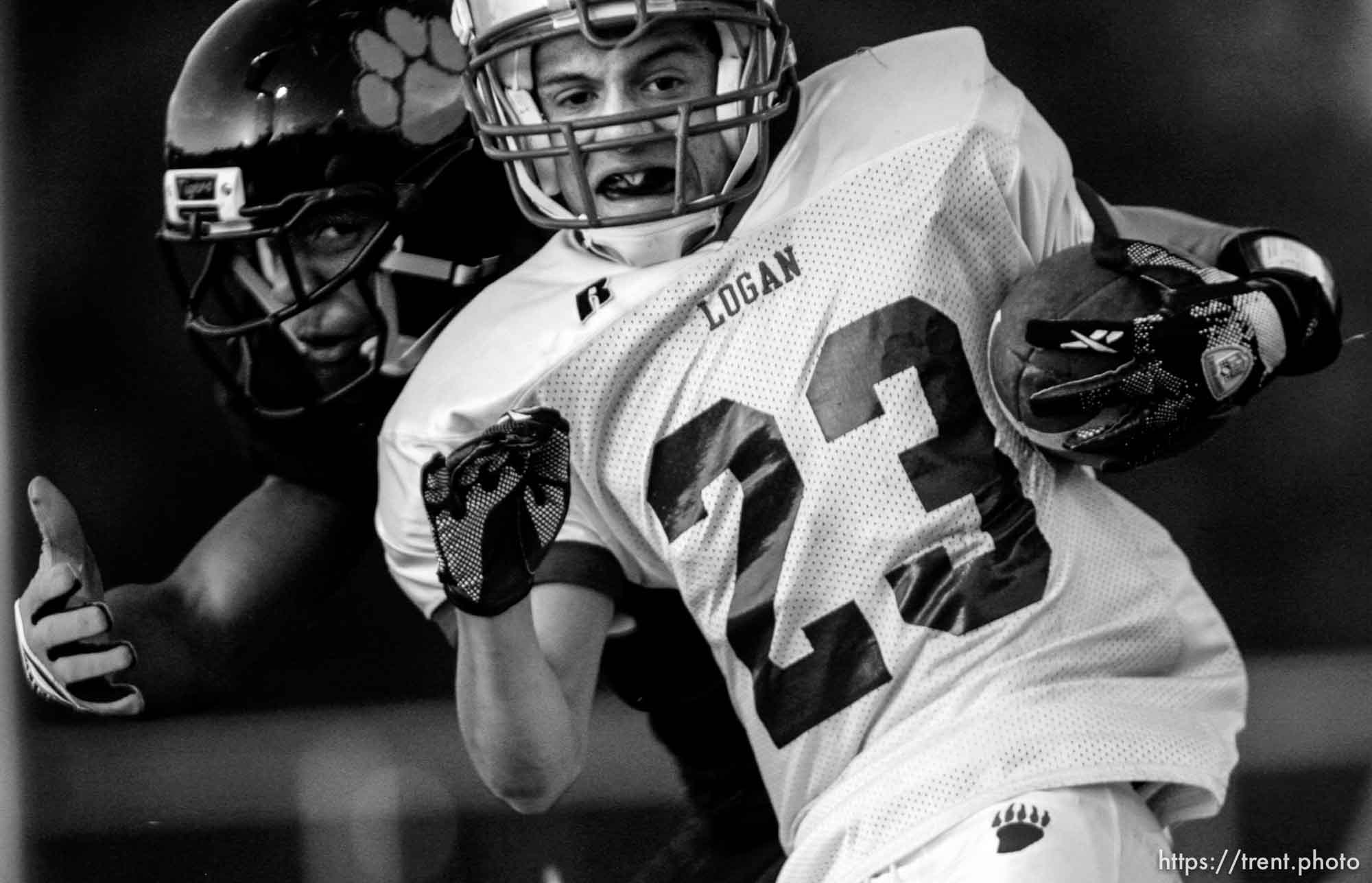 Trent Nelson  |  The Salt Lake Tribune
Logan's Greg Vernier is brought down by Ogden's Denzel Swinton (rear). Ogden vs. Logan High School football Friday, September 18 2009 in Ogden.