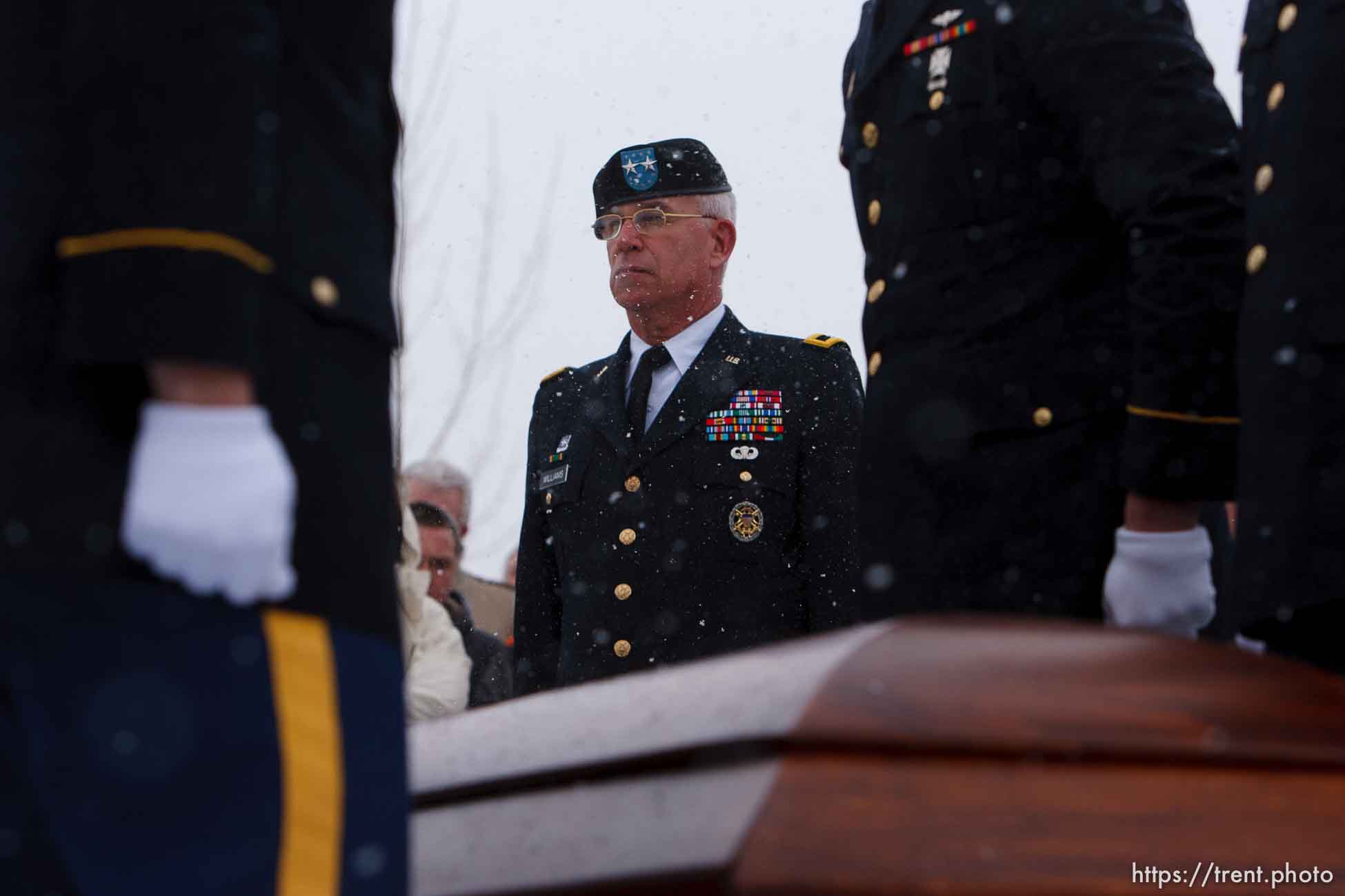 Major General Robert Williams presents a flag to Teena Nemelka, mother of Aaron Nemelka, who was killed in the Ft. Hood massacre and laid to rest at the Utah Veterans Memorial Park, Saturday, November 14 2009. Left of Teena is Aaron's sister-in-law Lindsey Nemelka, to Teena's right is her husband Michael Nemelka.