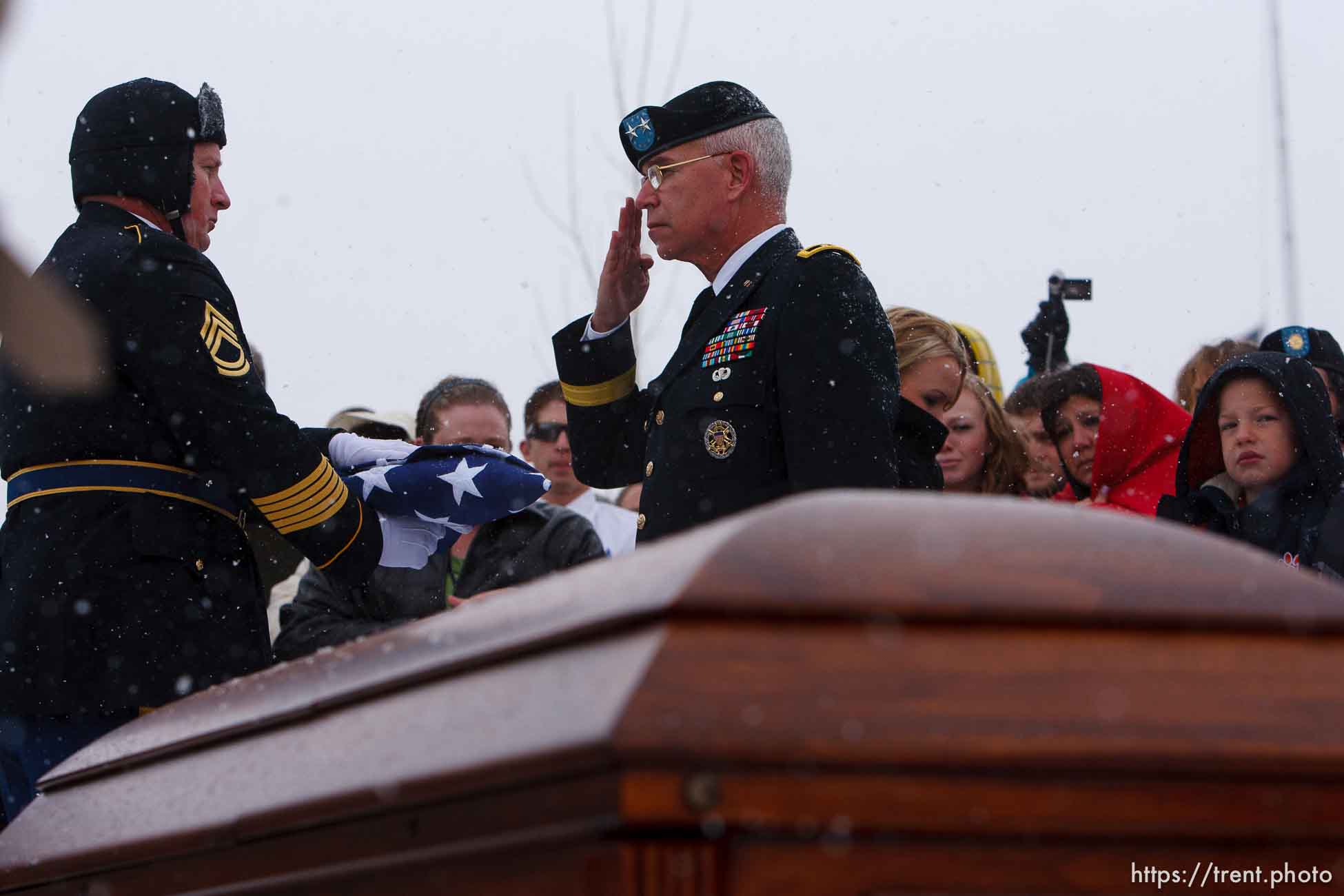 Major General Robert Williams presents a flag to Teena Nemelka, mother of Aaron Nemelka, who was killed in the Ft. Hood massacre and laid to rest at the Utah Veterans Memorial Park, Saturday, November 14 2009. Left of Teena is Aaron's sister-in-law Lindsey Nemelka, to Teena's right is her husband Michael Nemelka.