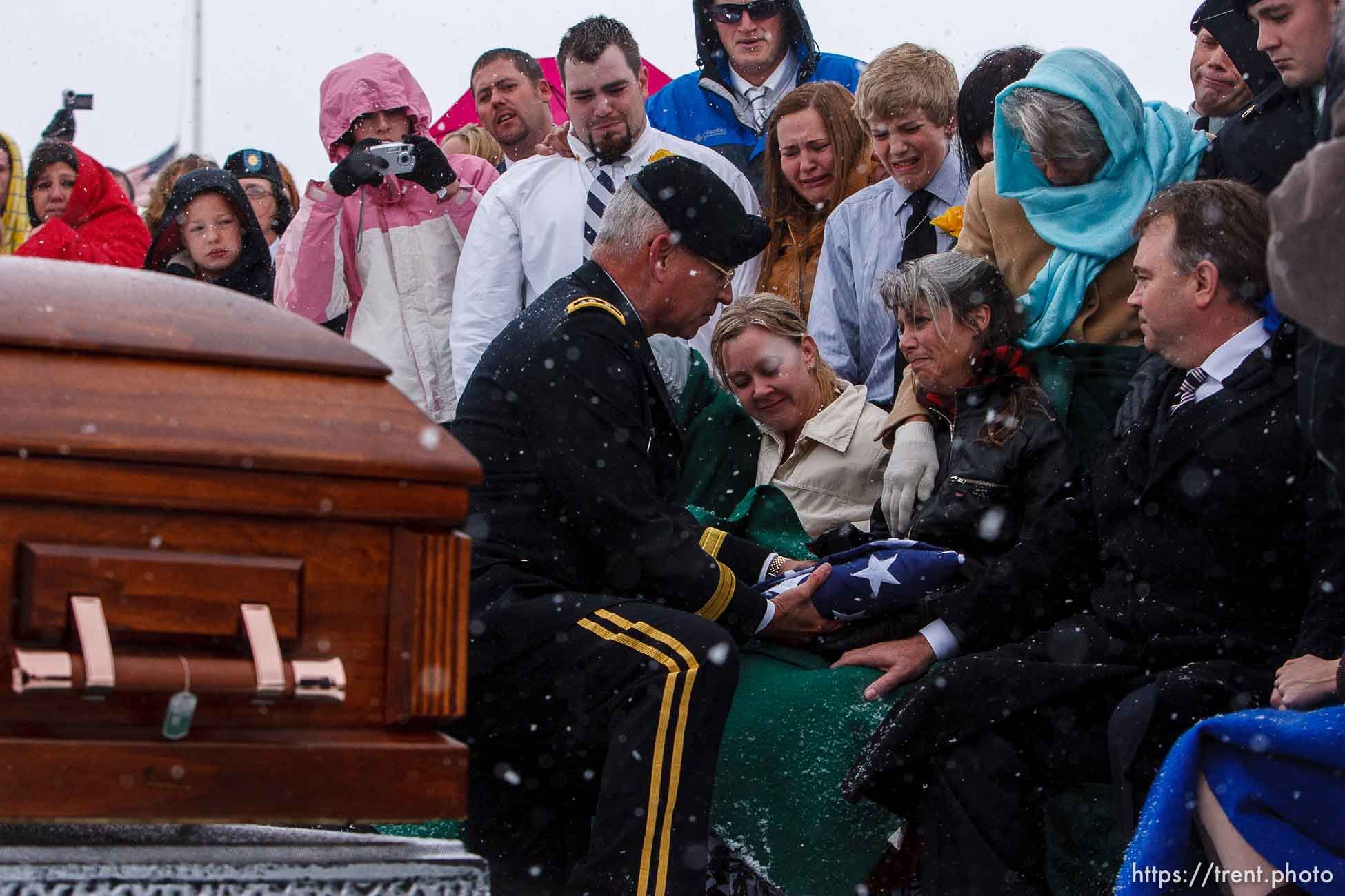 Major General Robert Williams presents a flag to Teena Nemelka, mother of Aaron Nemelka, who was killed in the Ft. Hood massacre and laid to rest at the Utah Veterans Memorial Park, Saturday, November 14 2009. Left of Teena is Aaron's sister-in-law Lindsey Nemelka, to Teena's right is her husband Michael Nemelka.