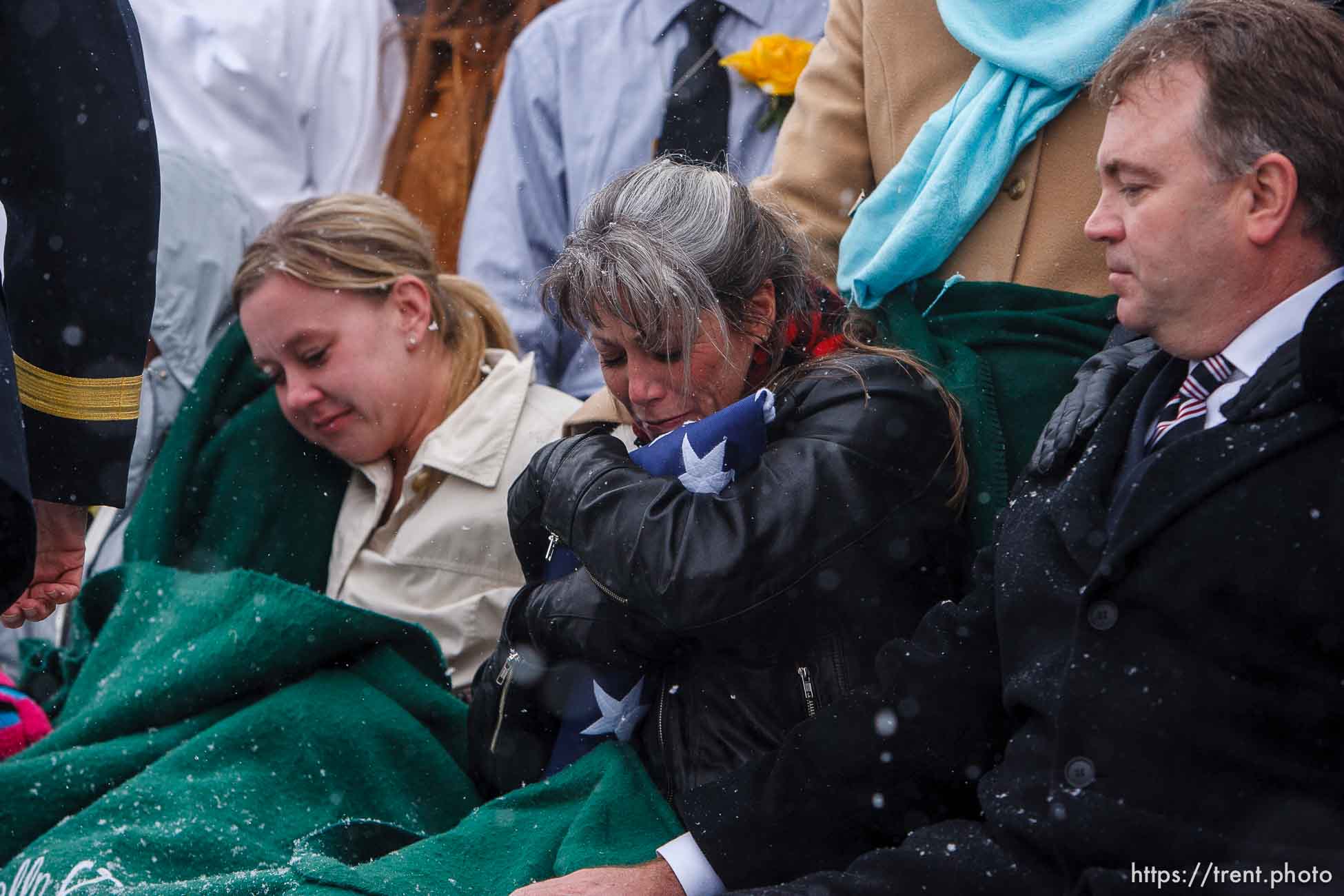 Teena Nemelka embraces the flag given to her at the burial of her son, Aaron Nemelka, who was killed in the Ft. Hood massacre and laid to rest at the Utah Veterans Memorial Park, Saturday, November 14 2009.