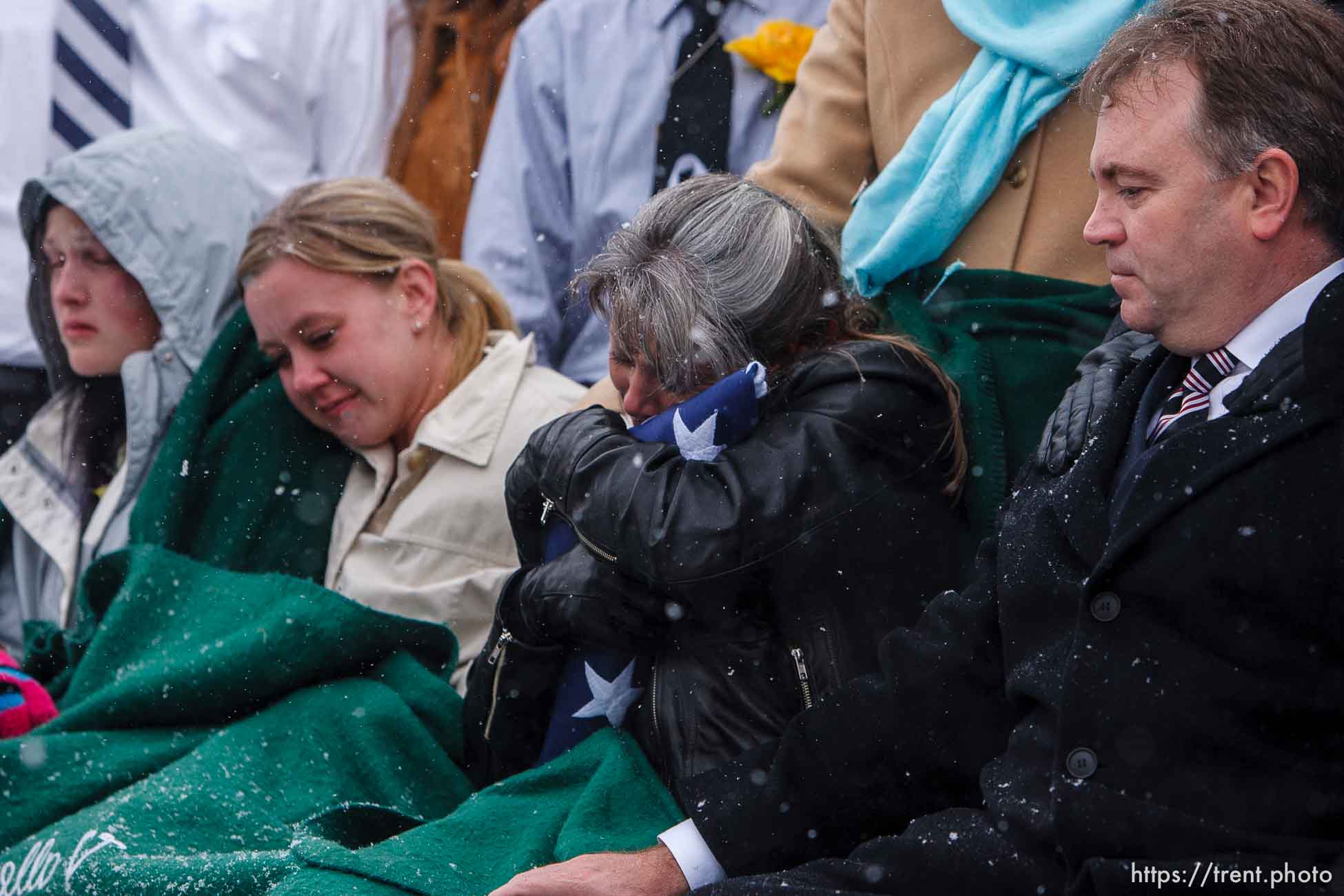 Teena Nemelka embraces the flag given to her at the burial of her son, Aaron Nemelka, who was killed in the Ft. Hood massacre and laid to rest at the Utah Veterans Memorial Park, Saturday, November 14 2009.