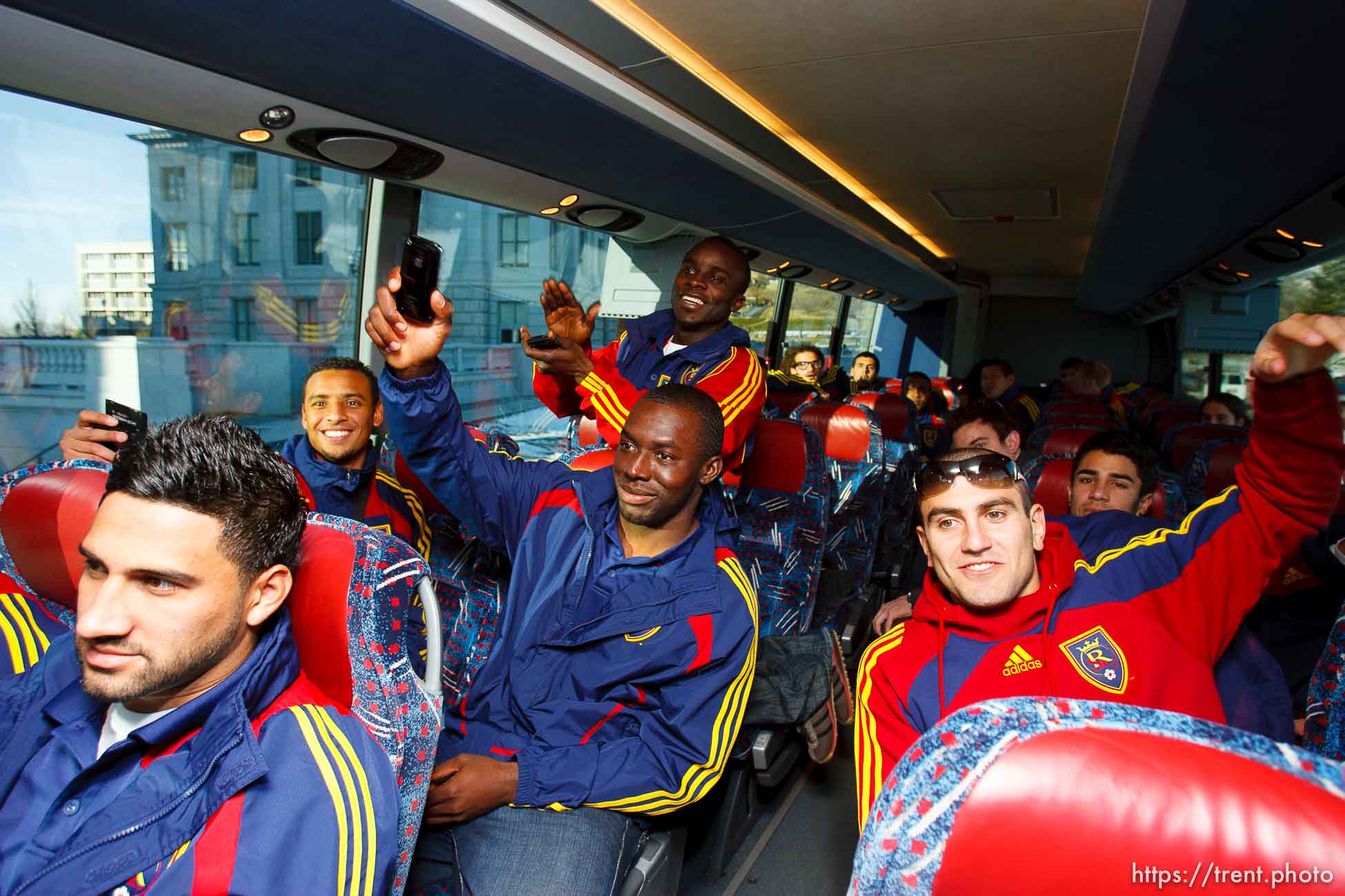 Real Salt Lake players laugh and clap as defender Robbie Russell (not pic'd) gets back on the bus at the state capitol, after missing the ride from the Governor's Mansion Tuesday, November 24 2009.