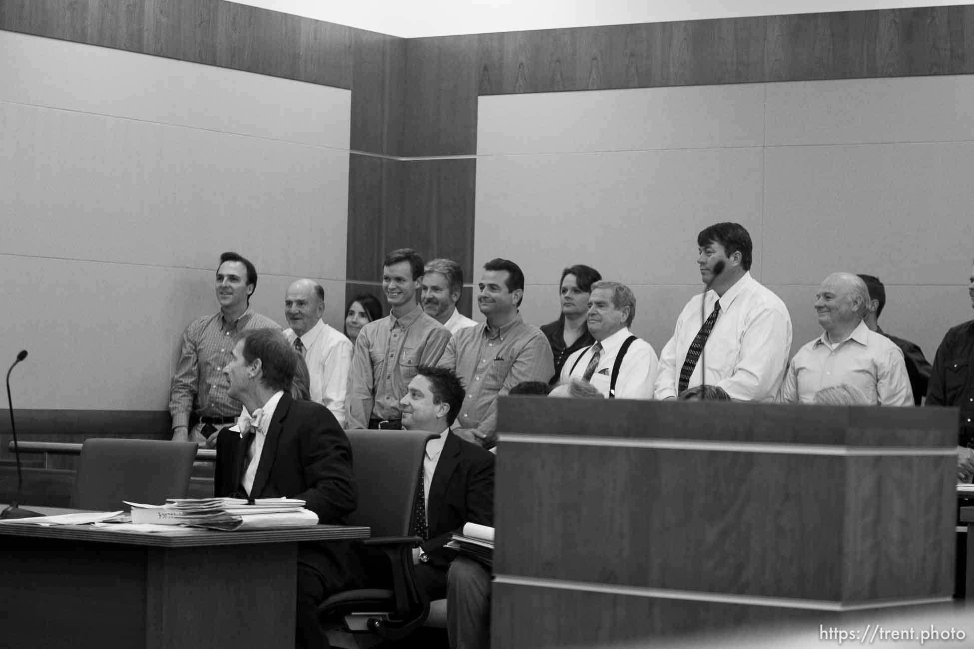 Trent Nelson  |  The Salt Lake Tribune
In the gallery, people stand to show honor and respect to Warren Jeffs, leader of the FLDS Church, appeared before Judge Terry Christiansen in Third District Court  Tuesday, September 7, 2010 in West Jordan, Utah. guy nielsen, wendell nielsen, mosiah jeffs, john wayman, merril jessop, willie jessop, vaughan taylor. back row gary batchelor and heidi mattingly foster