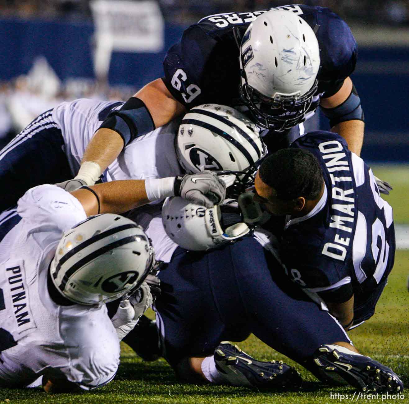 Trent Nelson  |  The Salt Lake Tribune
BYU defensive lineman Matt Putnam (41) pulls off Joey DeMartino's helmet during the first half. Utah State vs. BYU college football in Logan Friday, October 1, 2010.