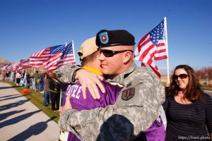 Trent Nelson  |  The Salt Lake Tribune
SFC Mike Jones, Utah National Guard, embraces his friend Jeff Malo, after returning home to Eagle Mountain. Family, friends and neighbors lined the streets of Eagle Mountain to welcome Jones home Friday, November 12, 2010. On his fourth deployment, Jones was injured in Afghanistan in September. Jones' wife Kindra Jones is at right.