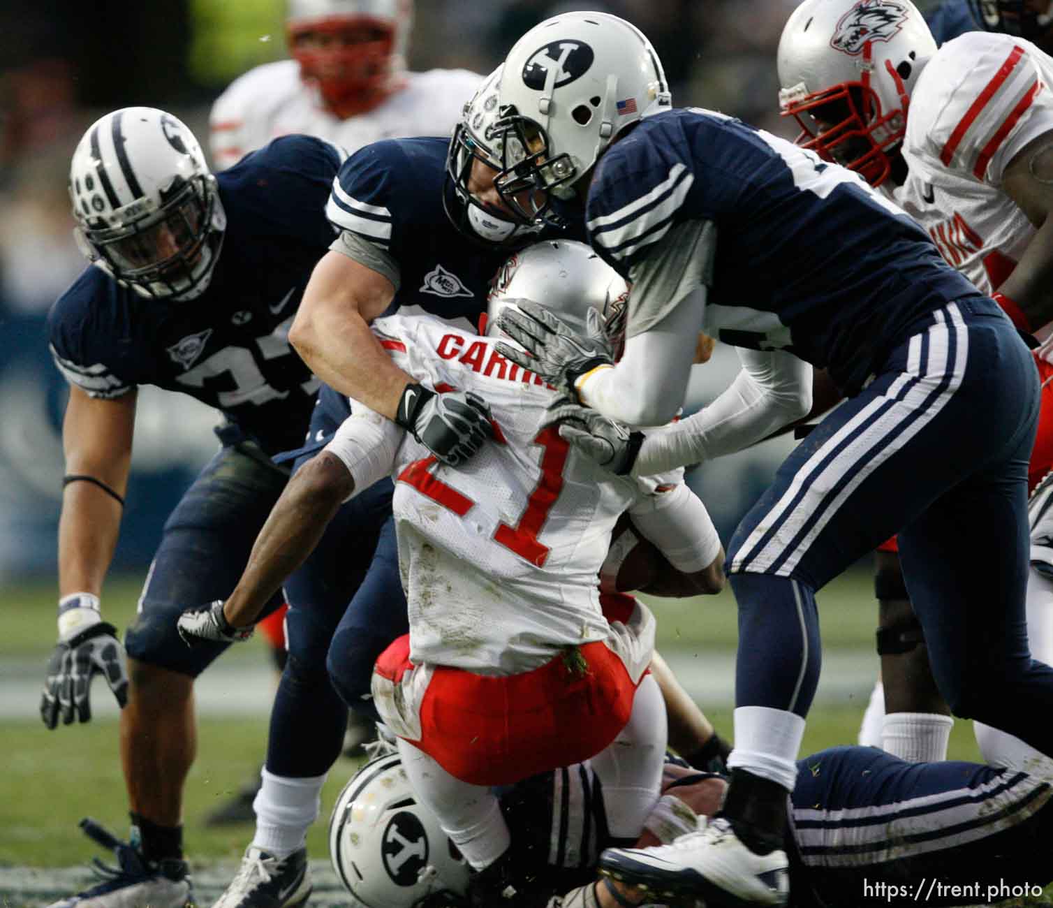 Trent Nelson  |  The Salt Lake Tribune
BYU defensive lineman Vic So'oto (37), BYU defensive back Zeke Mendenhall (30) and BYU linebacker Kyle Van Noy (45) bring down New Mexico's Kasey Carrier during the first half,  BYU vs. New Mexico, Saturday, November 20, 2010.