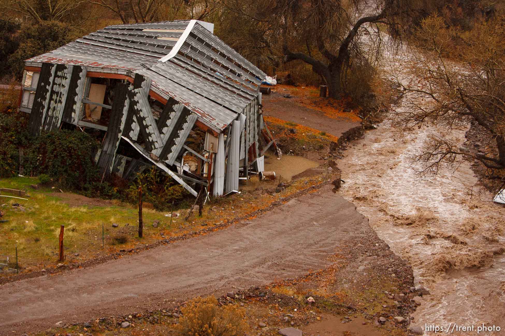 Trent Nelson  |  The Salt Lake Tribune
A road in Motoqua, Utah, washed out by high waters in Beaver Dam Wash, next to a structure damaged in the 2005 flood, Wednesday, December 22, 2010.