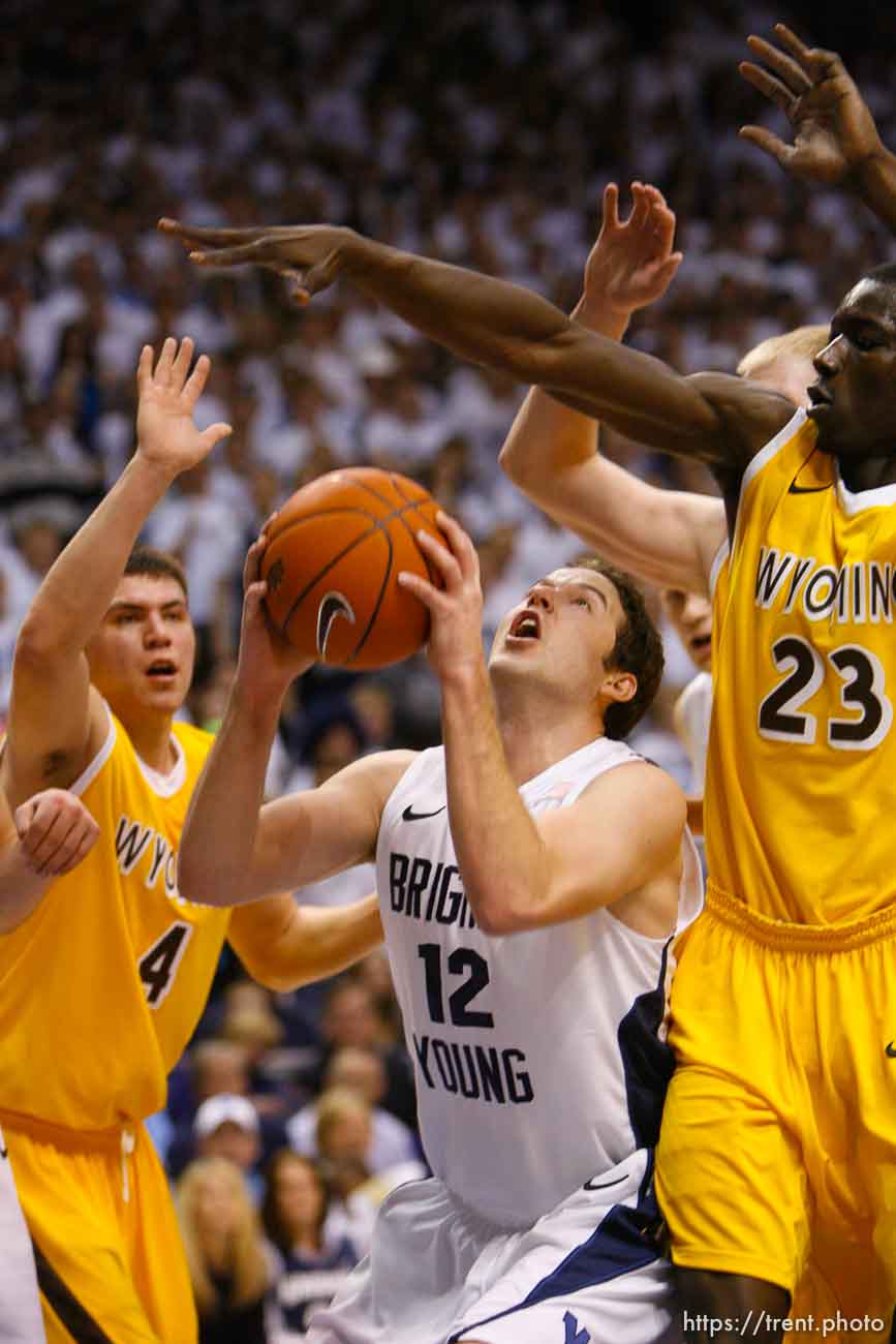 Trent Nelson  |  The Salt Lake Tribune
BYU's Logan Magnusson looks for a shot with Wyoming's Francisco Cruz, left, and Wyoming's Djibril Thiam defending as BYU hosts Wyoming, college basketball in Provo, Utah, Saturday, March 5, 2011.