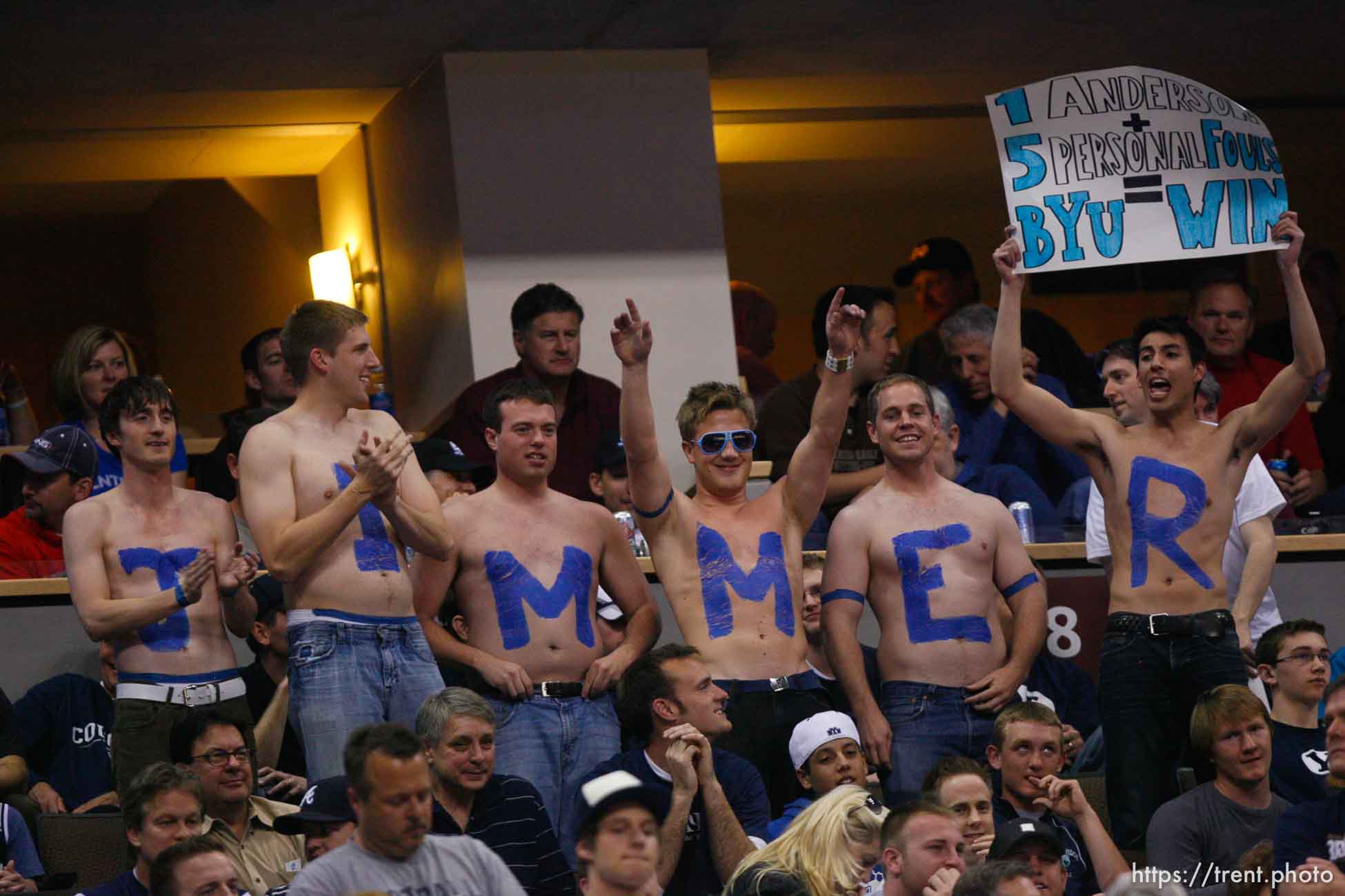 BYU fans with JIMMER spelled out on their chests, cheering as BYU defeats Gonzaga in the NCAA Tournament, men's college basketball at the Pepsi Center in Denver, Colorado, Saturday, March 19, 2011, earning a trip to the Sweet 16.