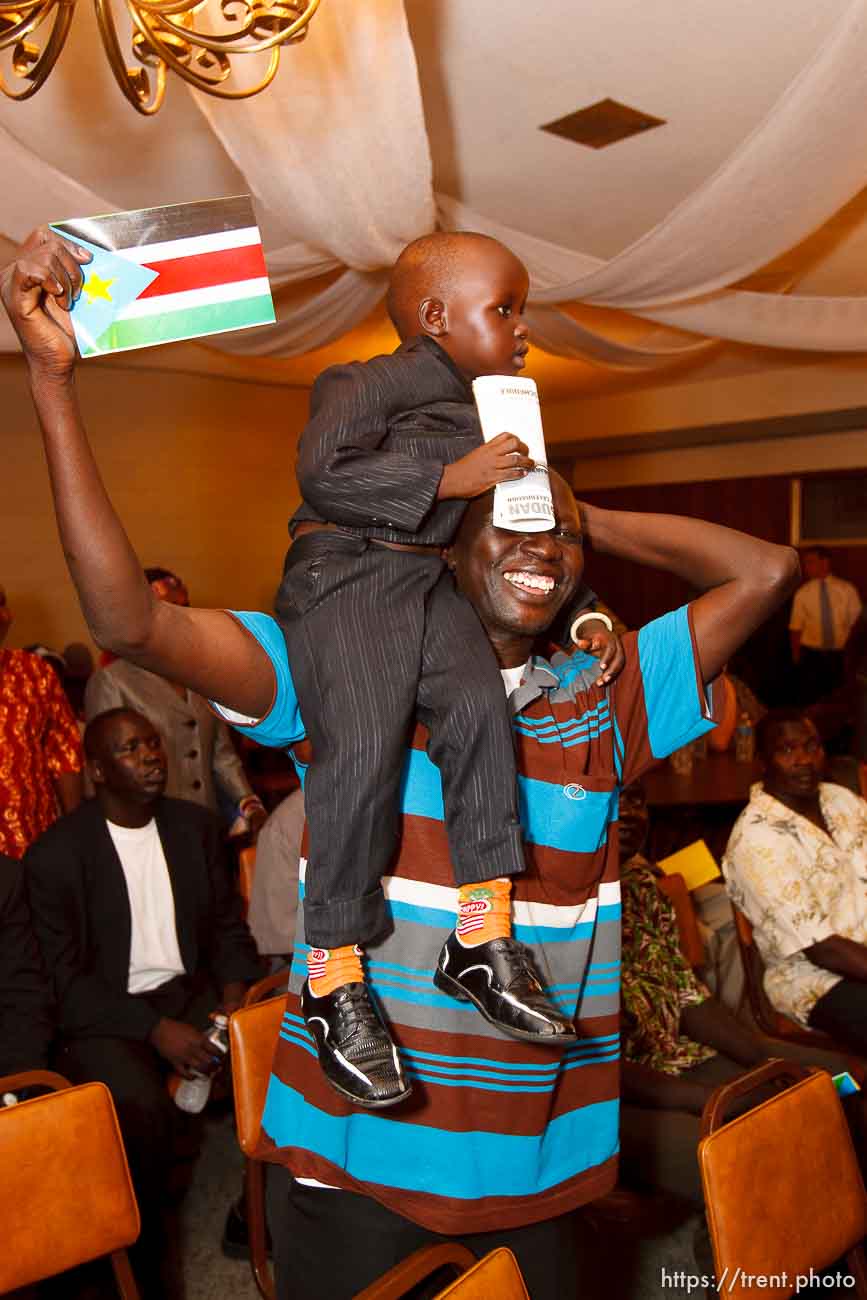 Trent Nelson  |  The Salt Lake Tribune
Mamer Ngong holds up Alayou Aew during the national anthem at the South Sudan Independence celebration in Salt Lake City, Utah, Saturday, July 9, 2011