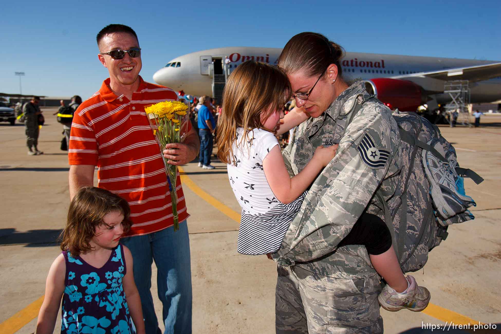 Trent Nelson  |  The Salt Lake Tribune
Tech Sergeant Laura Wright, right, holds her daughter Alexis while her husband Shane and daughter Katie wait their turns as the 729th Air Control Squadron returned to Hill Air Force Base in Layton, Utah, after six months in Afghanistan Wednesday, July 20, 2011.