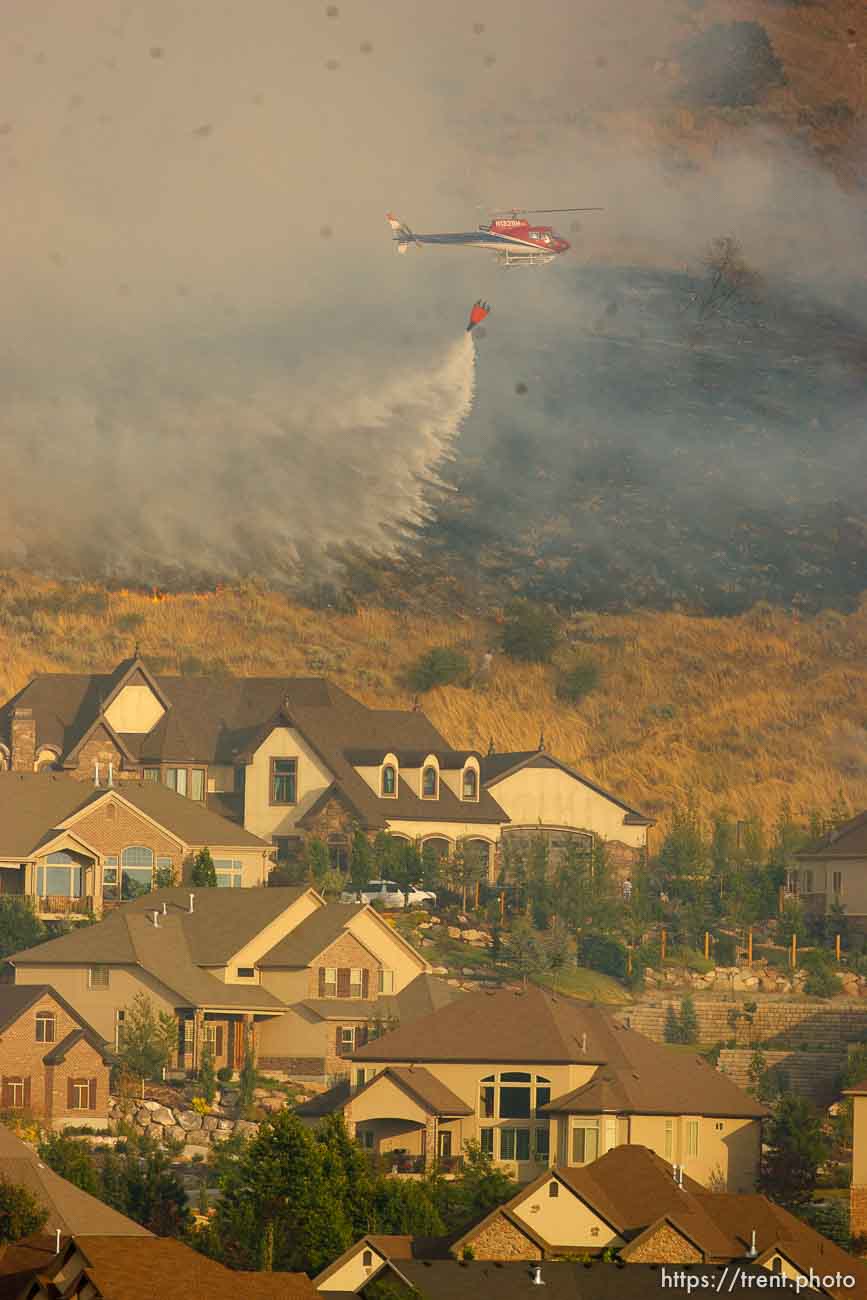 Trent Nelson  |  The Salt Lake Tribune
Helicopter water drop. A smoky fire burns near homes in Draper, Utah, Saturday, August 13, 2011.