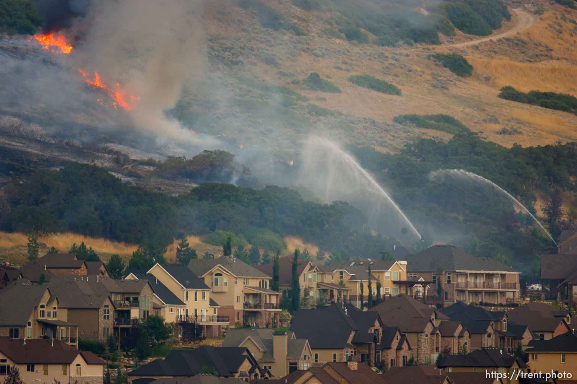 Trent Nelson  |  The Salt Lake Tribune
Crews work to control a fire burning near homes in Draper, Utah, Saturday, August 13, 2011.