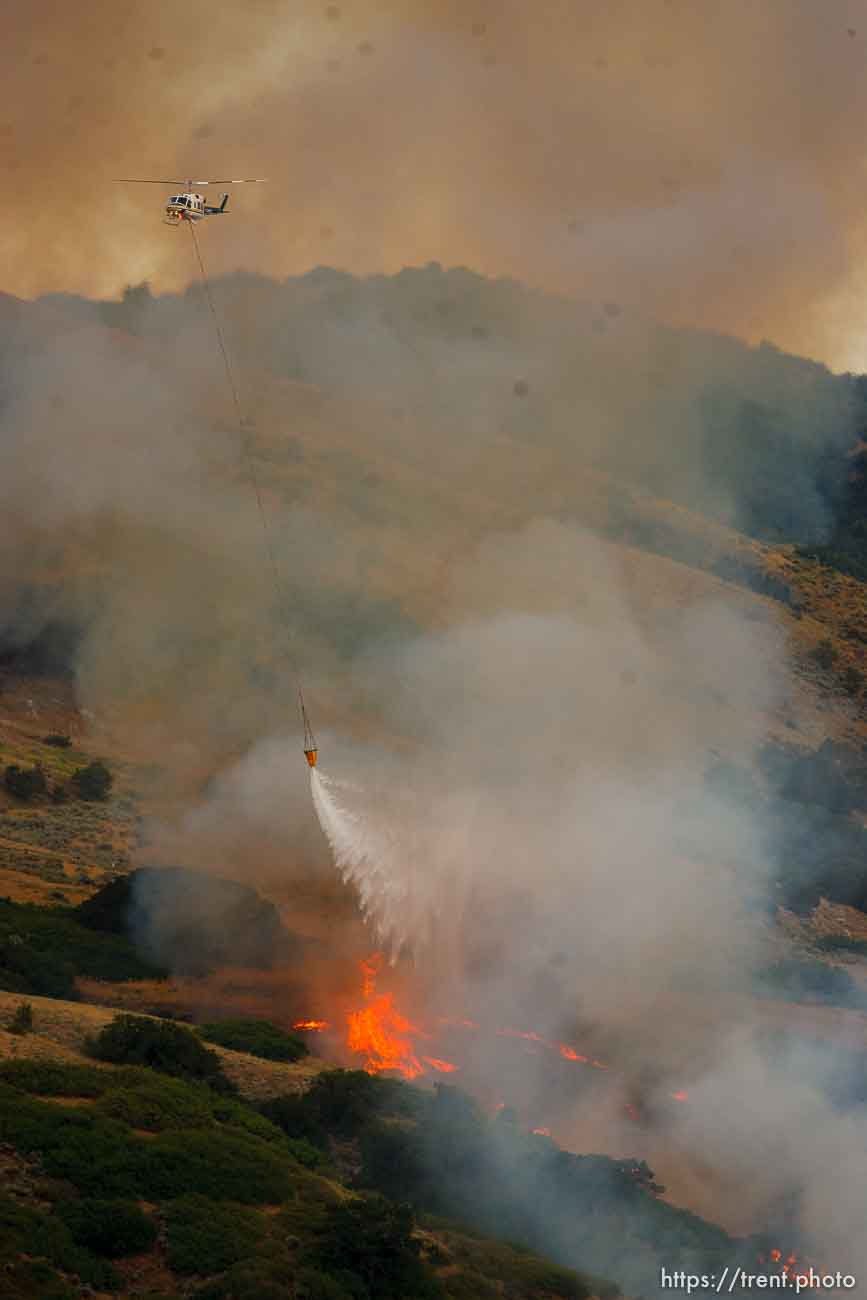 Trent Nelson  |  The Salt Lake Tribune
Helicopter water drop. A smoky fire burns near homes in Draper, Utah, Saturday, August 13, 2011.