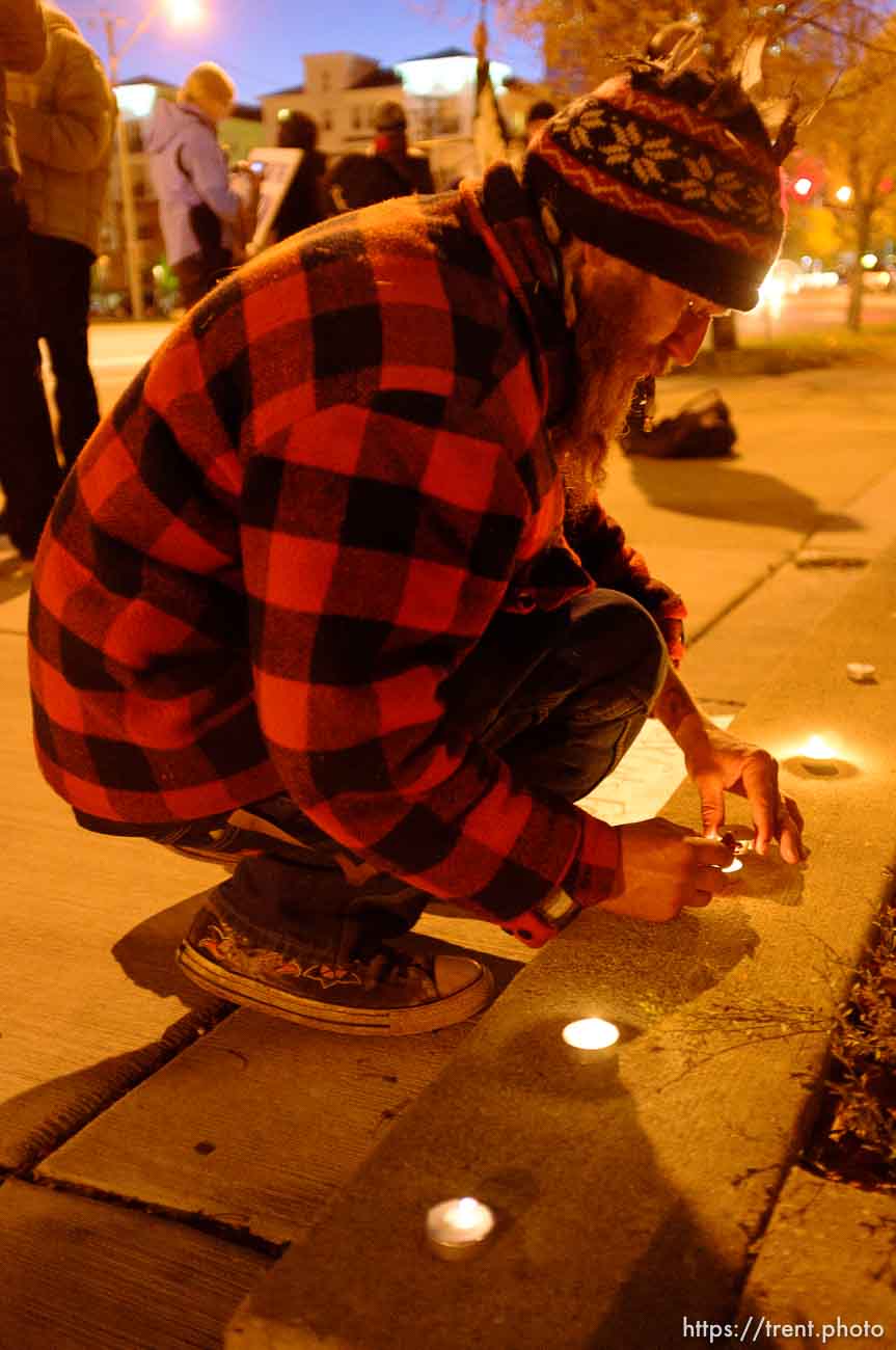 Trent Nelson  |  The Salt Lake Tribune
Braden Jordan lights candles in front of the Public Safety Building in Salt Lake City, Utah on Wednesday, October 26, 2011. About two dozen protesters with Occupy Salt Lake marched from Pioneer Park to the Public Safety Building. They lit candles to show appreciation for the Salt Lake City police, but to protest the actions of the police in Oakland (California).