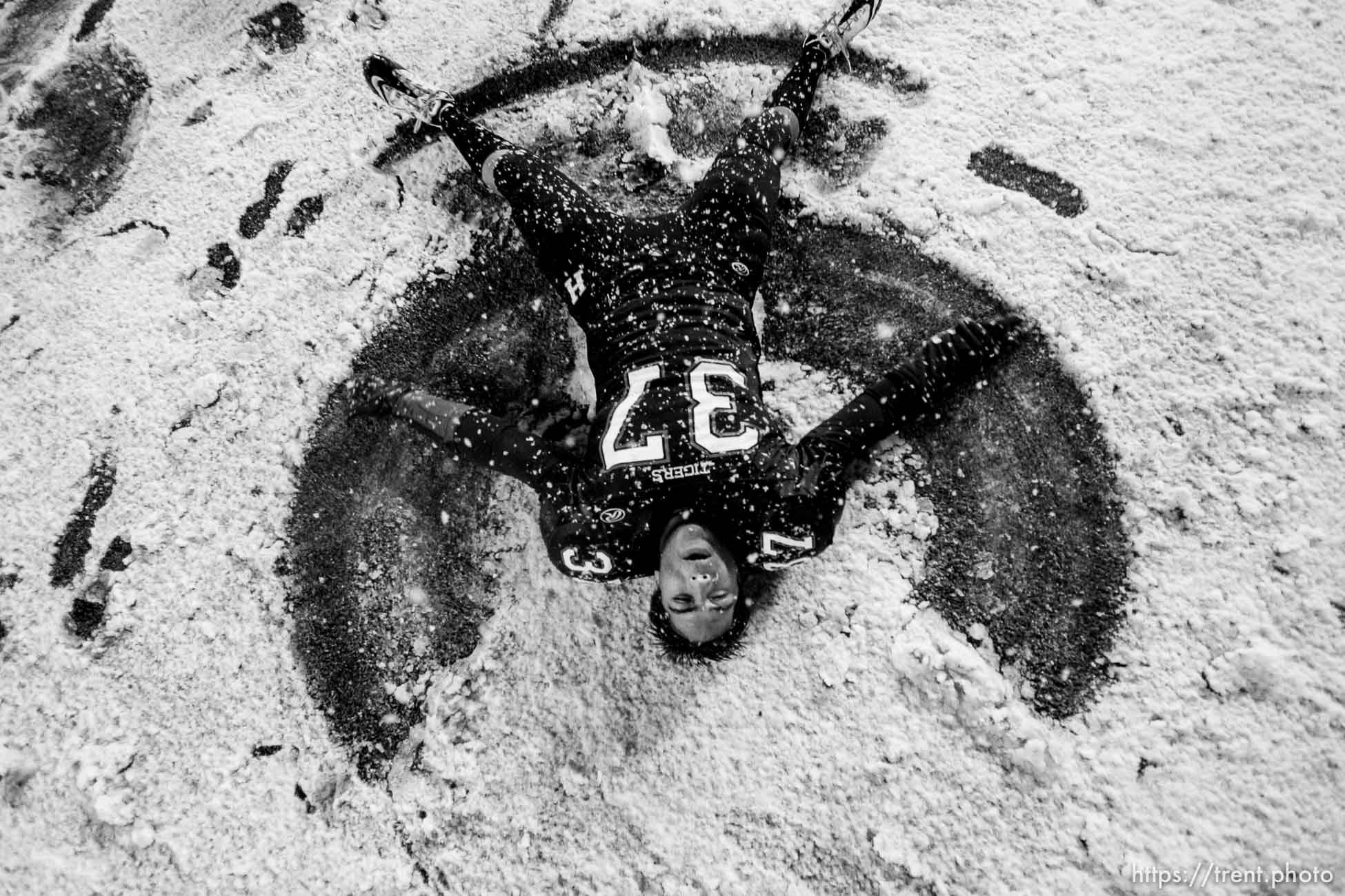 Trent Nelson  |  The Salt Lake Tribune
Hurricane's Joseph Takau makes a snow angel on the field after Hurricane defeated Desert Hills 21-0 in the 3A State Championship high school football game at Rice-Eccles Stadium in Salt Lake City, Utah, Friday, November 18, 2011.