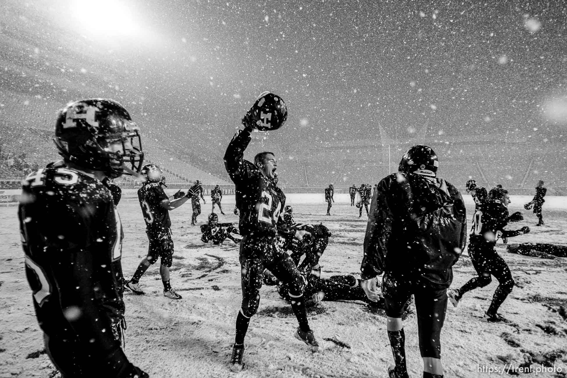 Trent Nelson  |  The Salt Lake Tribune
Hurricane's Tyson Long (24) and teammates celebrate in the snow after they defeated Desert Hills 21-0 in the 3A State Championship high school football game at Rice-Eccles Stadium in Salt Lake City, Utah, Friday, November 18, 2011.