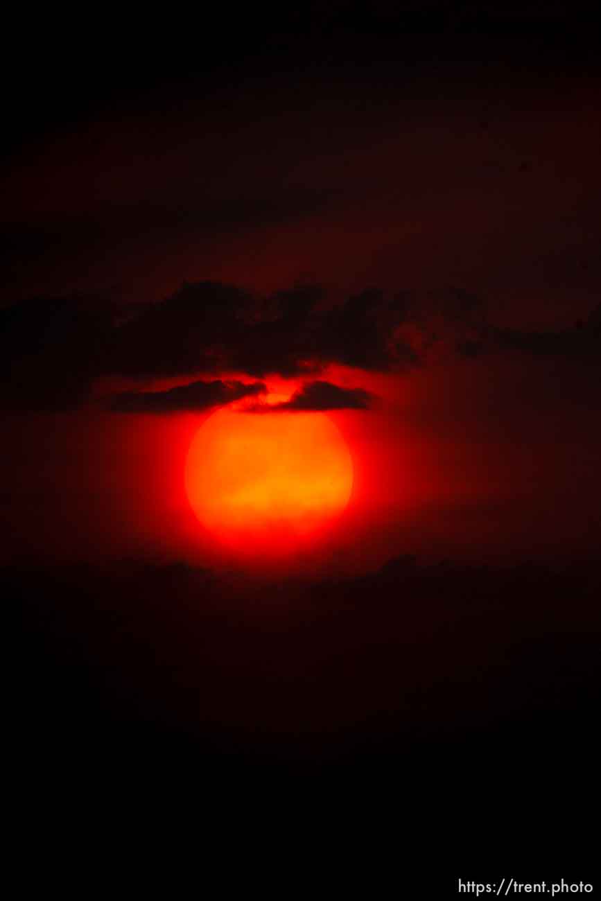 Trent Nelson  |  The Salt Lake Tribune
The setting sun burns through the haze over Salt Lake City, Utah Thursday, August 16, 2012.