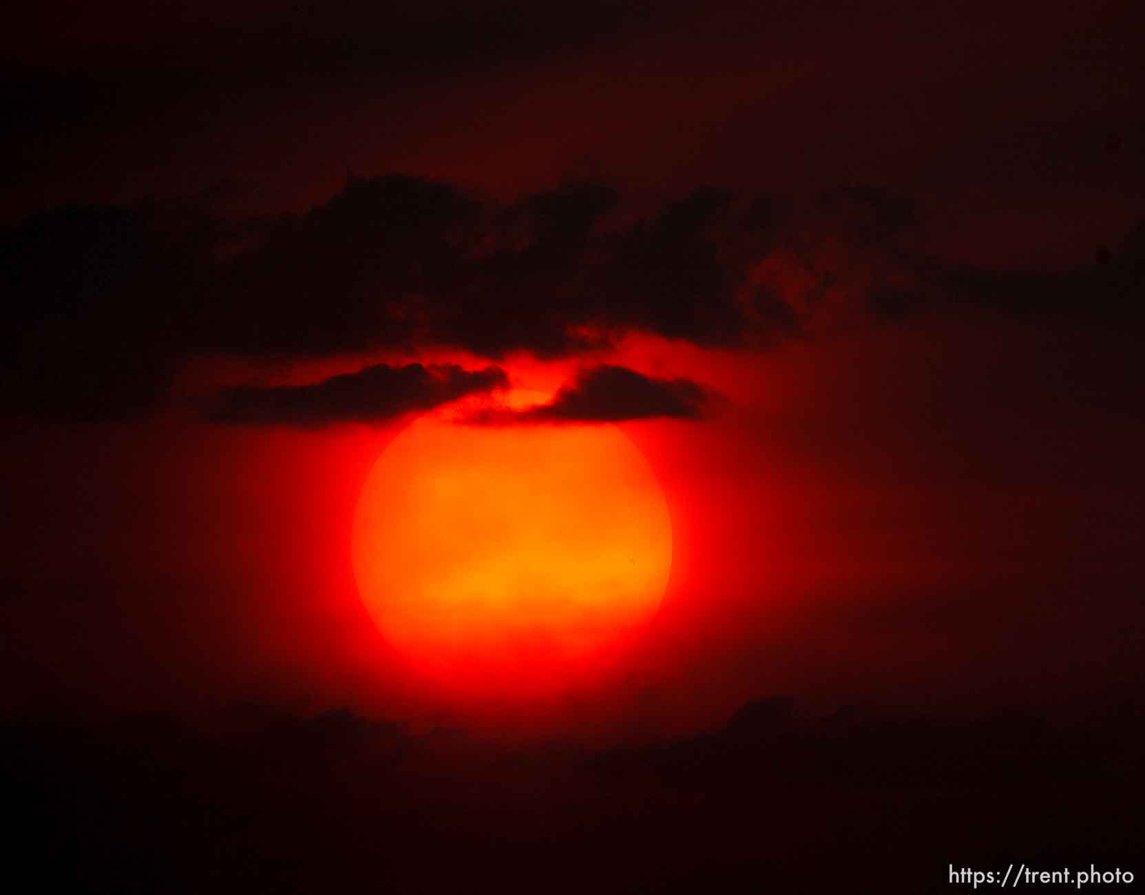 Trent Nelson  |  The Salt Lake Tribune
The setting sun burns through the haze over Salt Lake City, Utah Thursday, August 16, 2012.