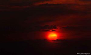 Trent Nelson  |  The Salt Lake Tribune
The setting sun burns through the haze over Salt Lake City, Utah Thursday, August 16, 2012.