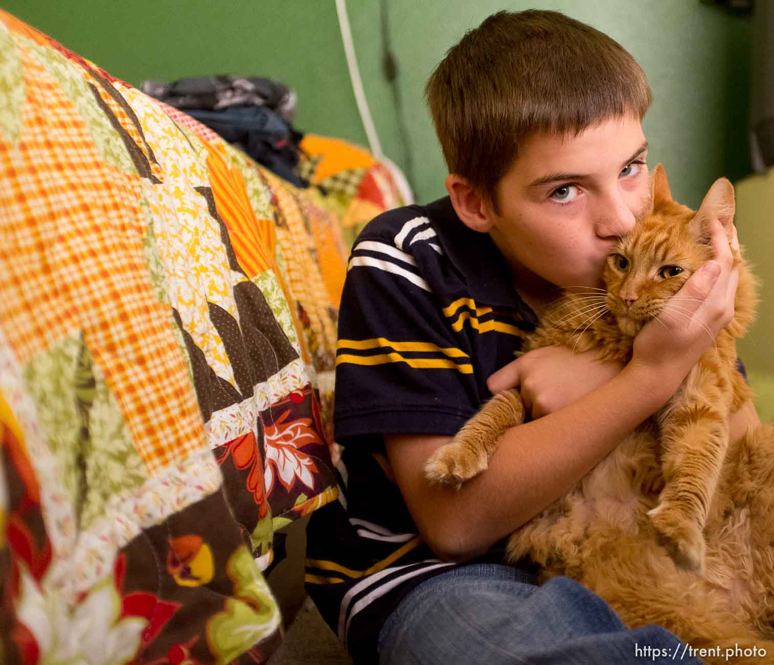 Trent Nelson  |  The Salt Lake Tribune
Michael Chambers kisses his foster mom's pet cat in his bedroom at the foster home where he lives in Eagle Mountain, Utah, Wednesday, September 12, 2012. Due to the lack of services for children with autism, a small number of families are turning their children, like Chambers, over to the child welfare system each year desperate for the services they can get in state custody.