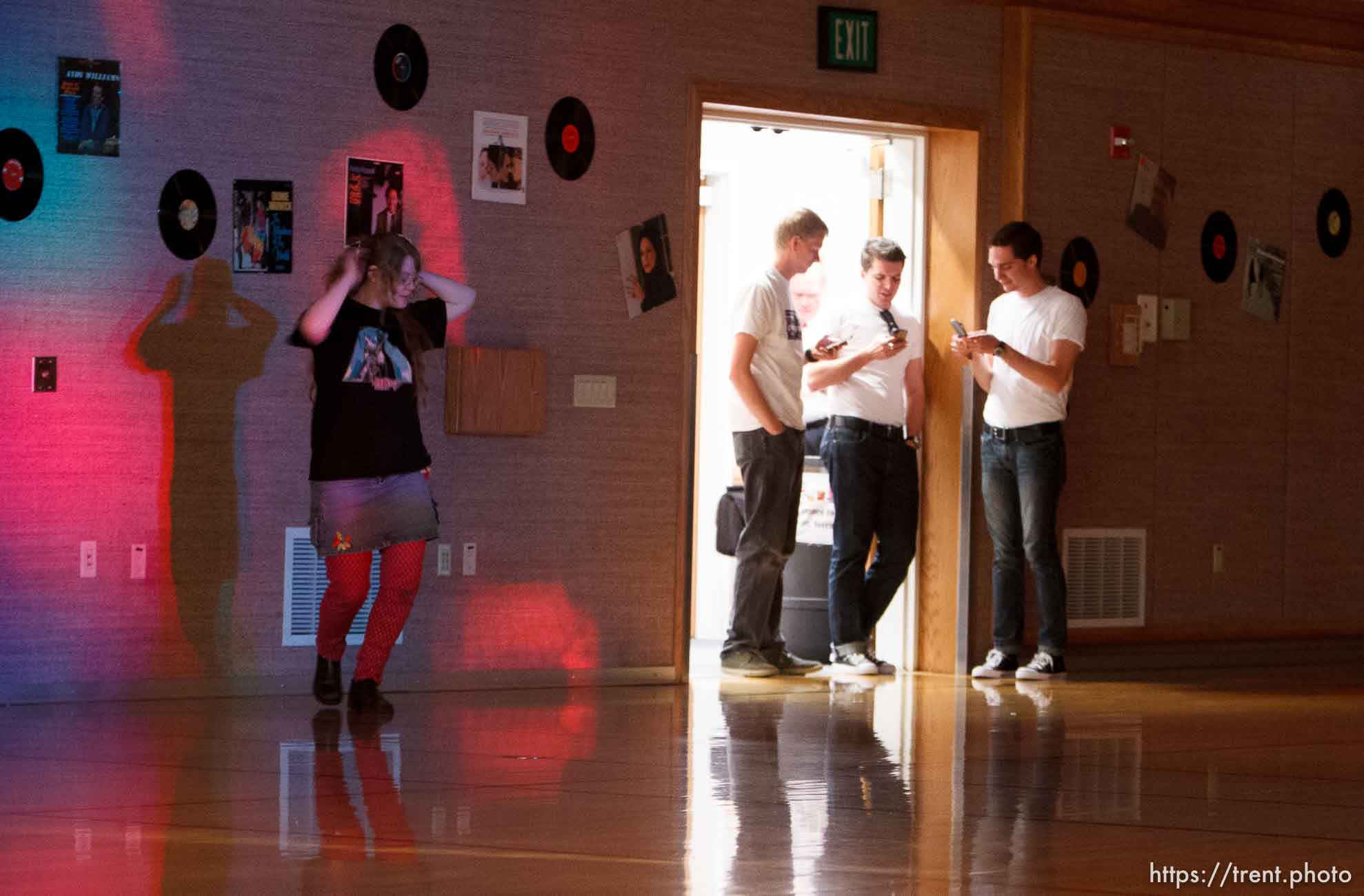 Trent Nelson  |  The Salt Lake Tribune
A young woman dances by herself as three eligible bachelors check their phones at a dance at the Salt Lake University Institute of Religion, Friday November 16, 2012 in Salt Lake City.