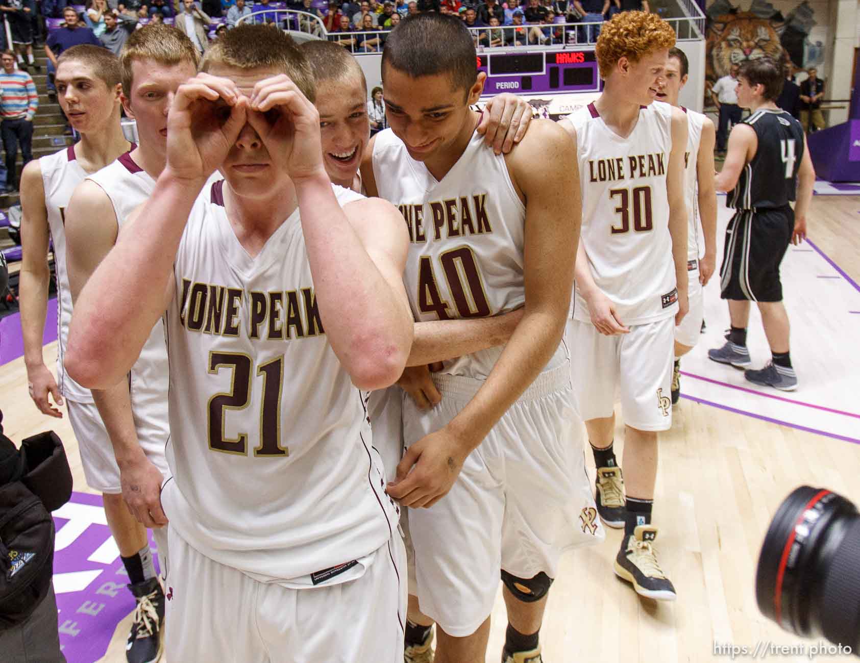 Lone Peak's Talon Shumway signals to photographers after beating Alta High School in the 5A basketball state championship game Saturday, March 2, 2013 in Ogden.