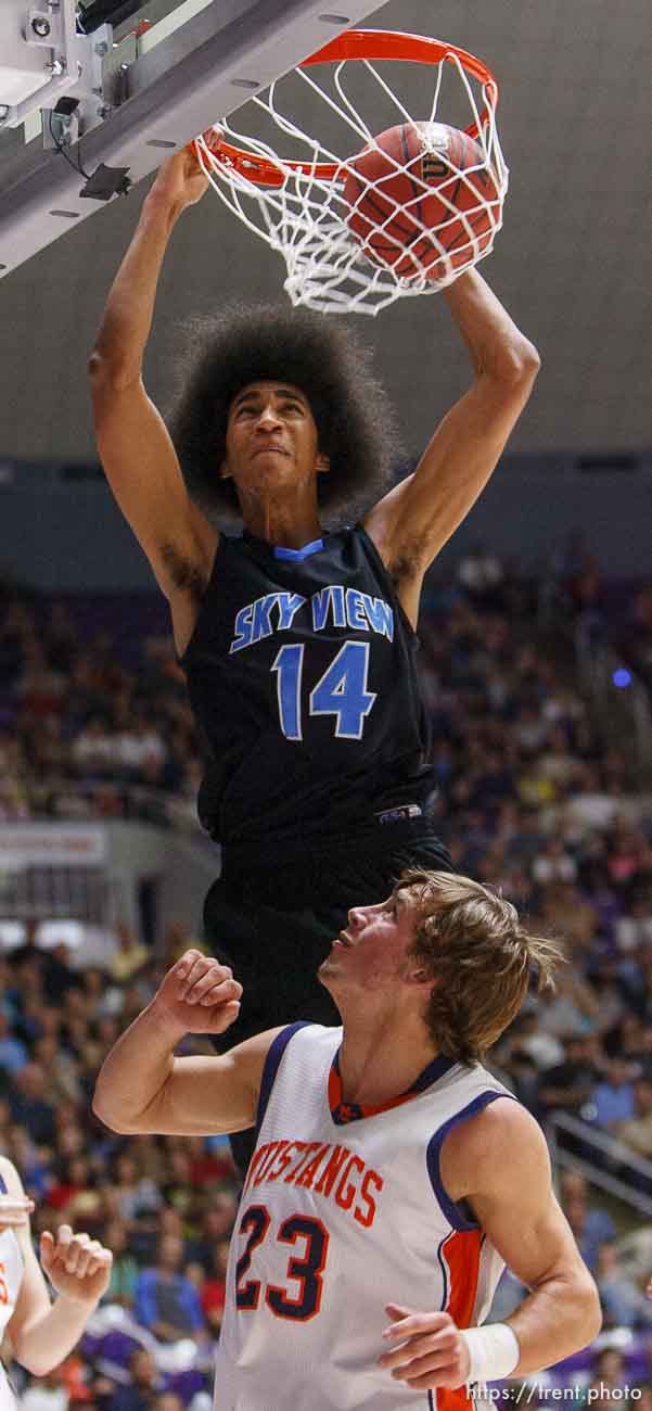 Sky View's Jalen Moore dunks over Mountain Crest's Gaje Fergusen as Mountain Crest faces Sky View High School in the 4A basketball state championship game Saturday, March 2, 2013 in Ogden.