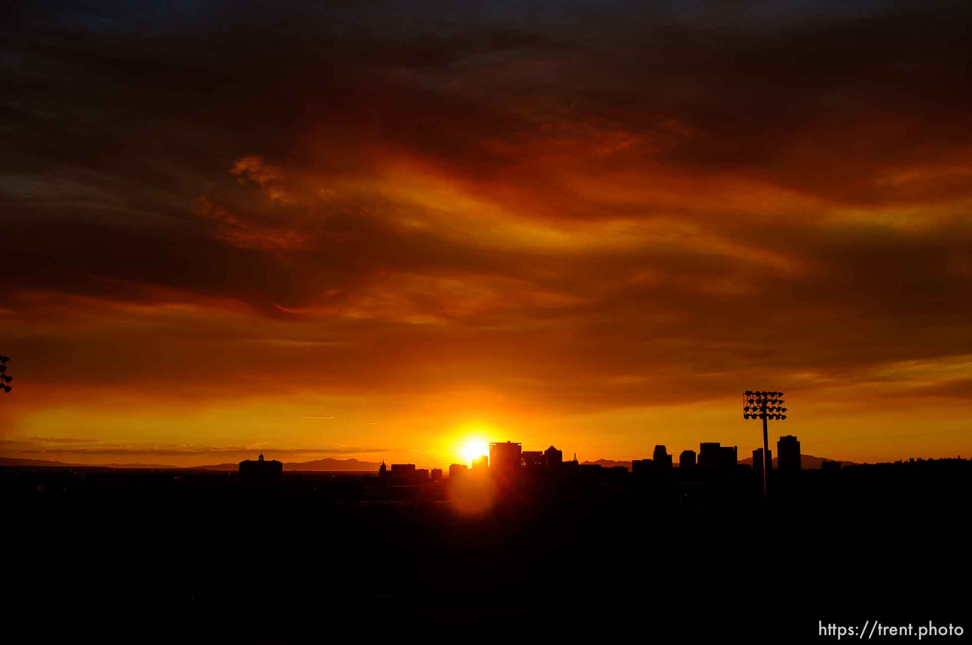 Trent Nelson  |  The Salt Lake Tribune
The sun sets over a smoky Salt Lake City skyline Sunday August 11, 2013.