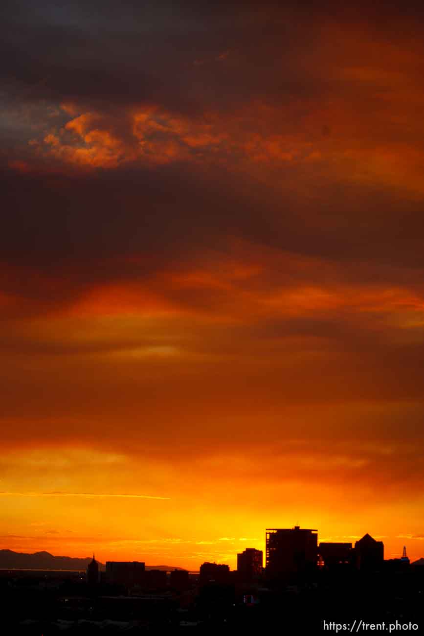 Trent Nelson  |  The Salt Lake Tribune
The sun sets over a smoky Salt Lake City skyline Sunday August 11, 2013.