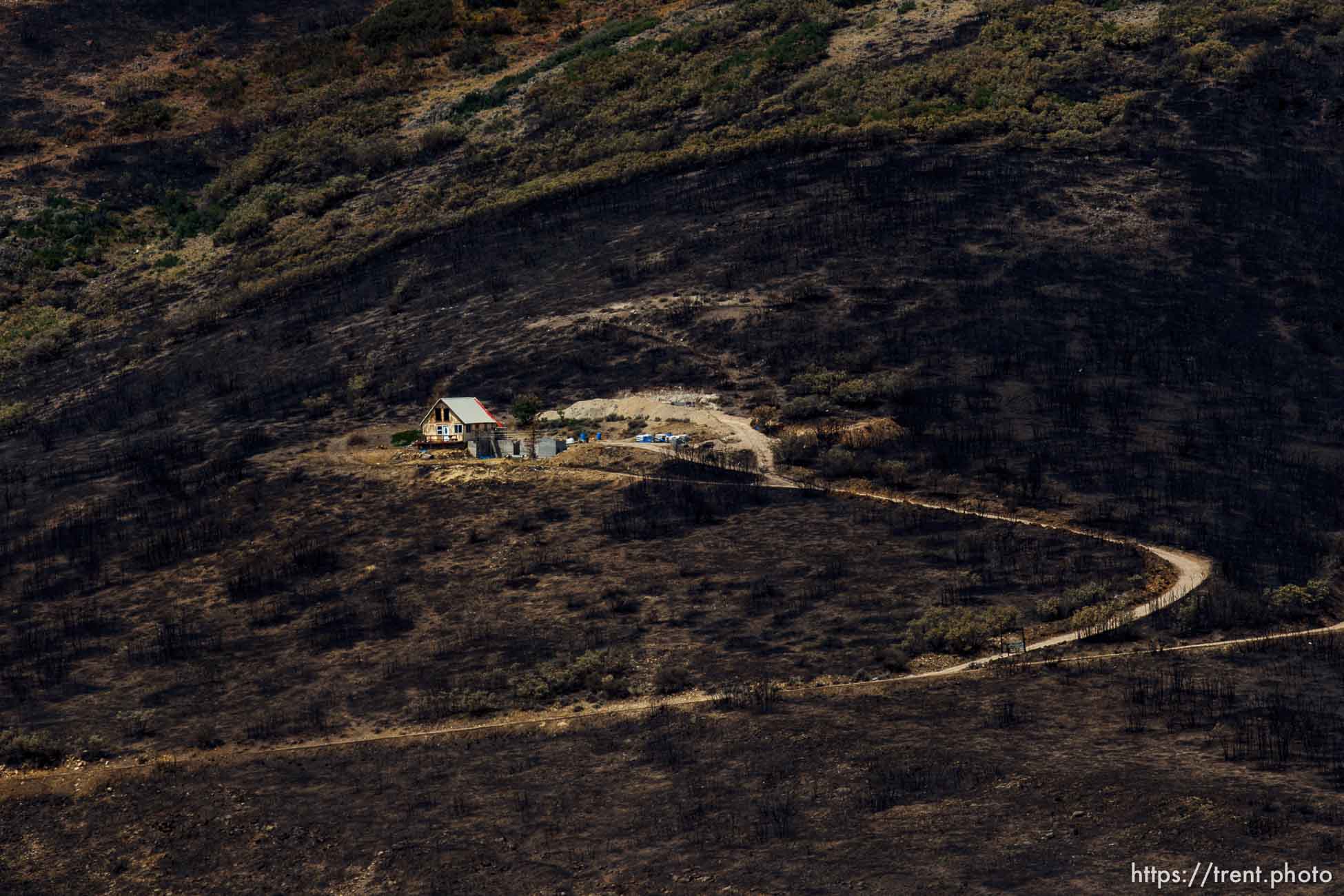 Trent Nelson  |  The Salt Lake Tribune
A home spared from the fire in the Lake Rockport Estates, Thursday August 22, 2013. A Utah program requires new construction to reduce brush and trees around houses. This fuels mitigation strategy creates a defensible space so that wildfires have a decreased chance of burning structures.