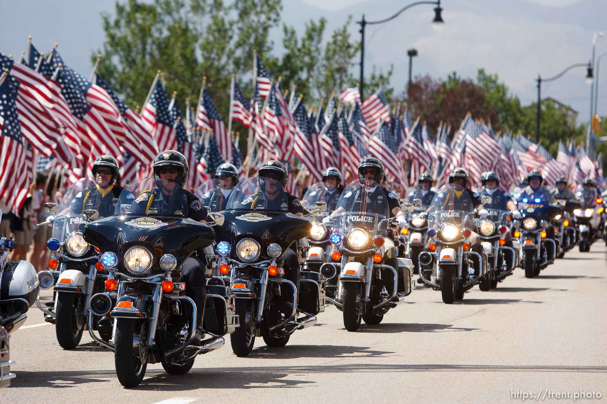 Trent Nelson  |  The Salt Lake Tribune
Flags fly as the funeral procession for Sgt. Derek Johnson, the Draper police officer who was shot to death on Sunday morning, passes through Draper Friday, September 6, 2013.