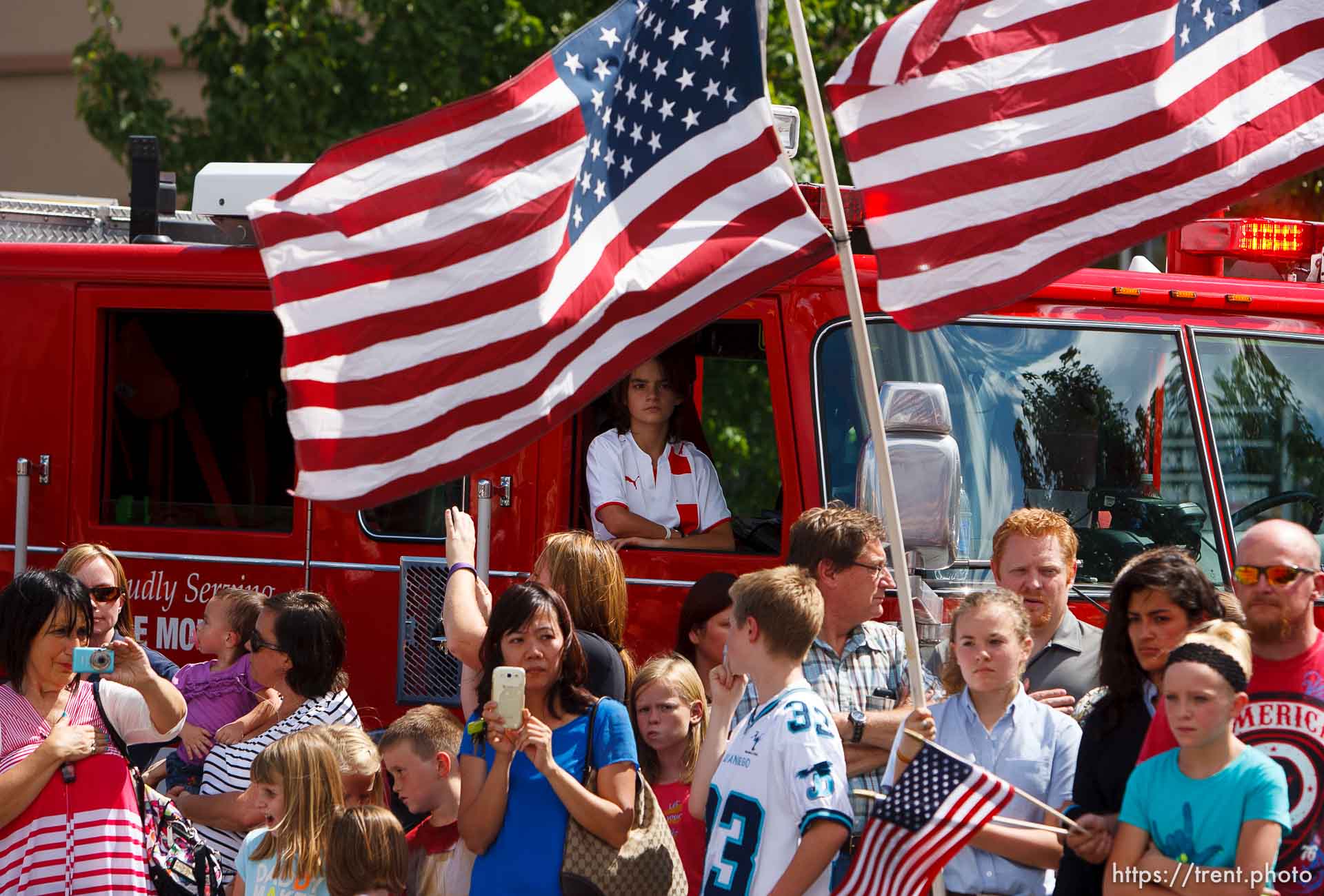 Trent Nelson  |  The Salt Lake Tribune
Flags fly as the funeral procession for Sgt. Derek Johnson, the Draper police officer who was shot to death on Sunday morning, passes through Draper Friday, September 6, 2013.