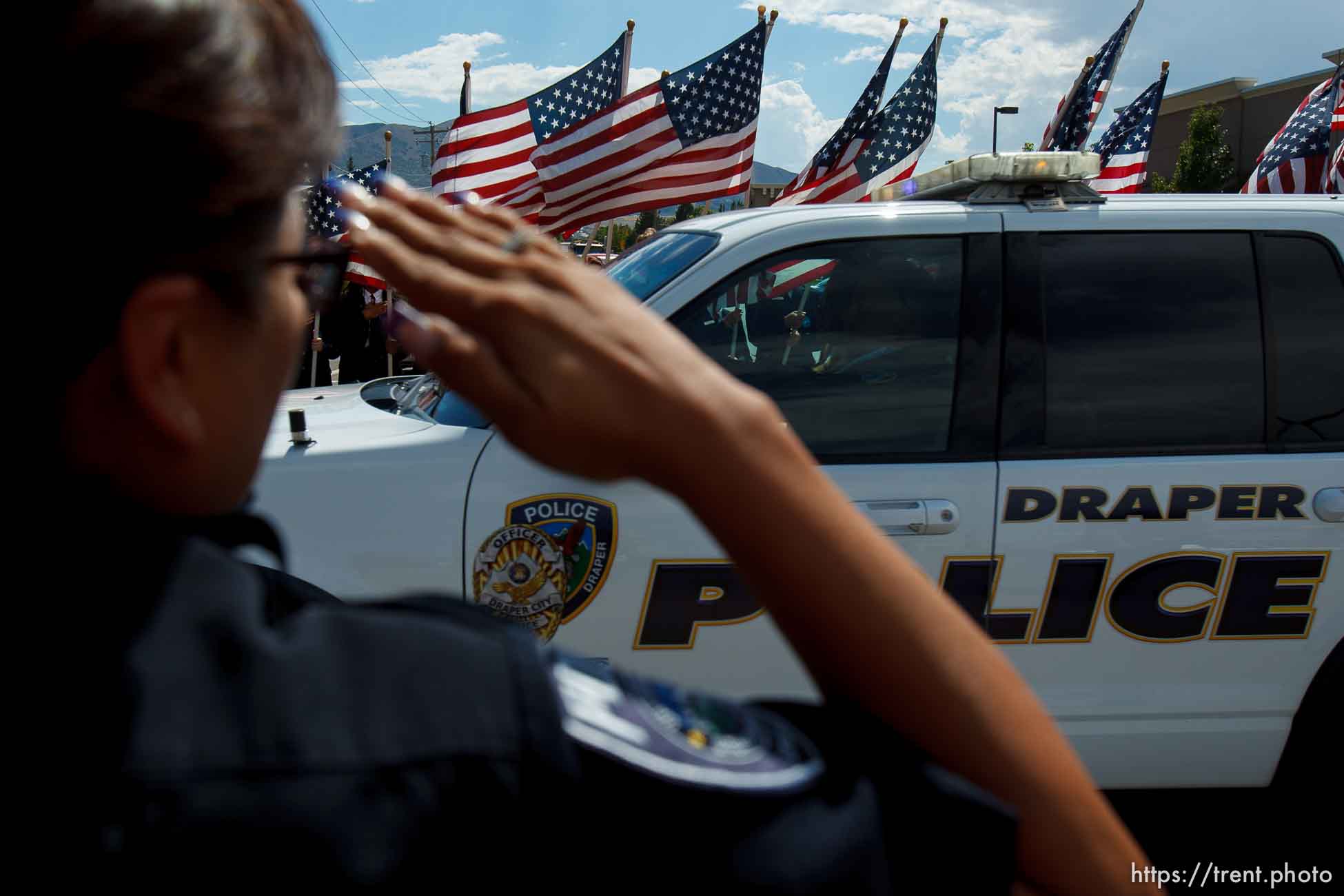 Trent Nelson  |  The Salt Lake Tribune
Flags fly as the funeral procession for Sgt. Derek Johnson, the Draper police officer who was shot to death on Sunday morning, passes through Draper Friday, September 6, 2013.