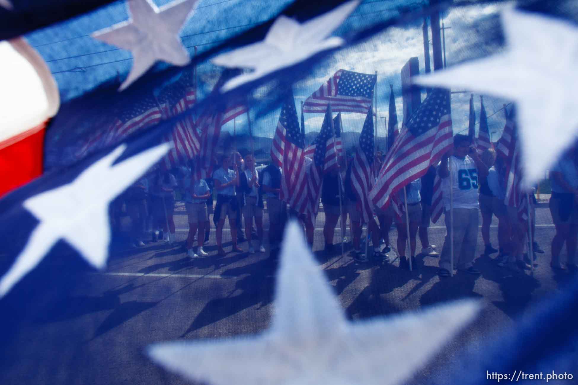 Trent Nelson  |  The Salt Lake Tribune
Flags fly as the funeral procession for Sgt. Derek Johnson, the Draper police officer who was shot to death on Sunday morning, passes through Draper Friday, September 6, 2013.