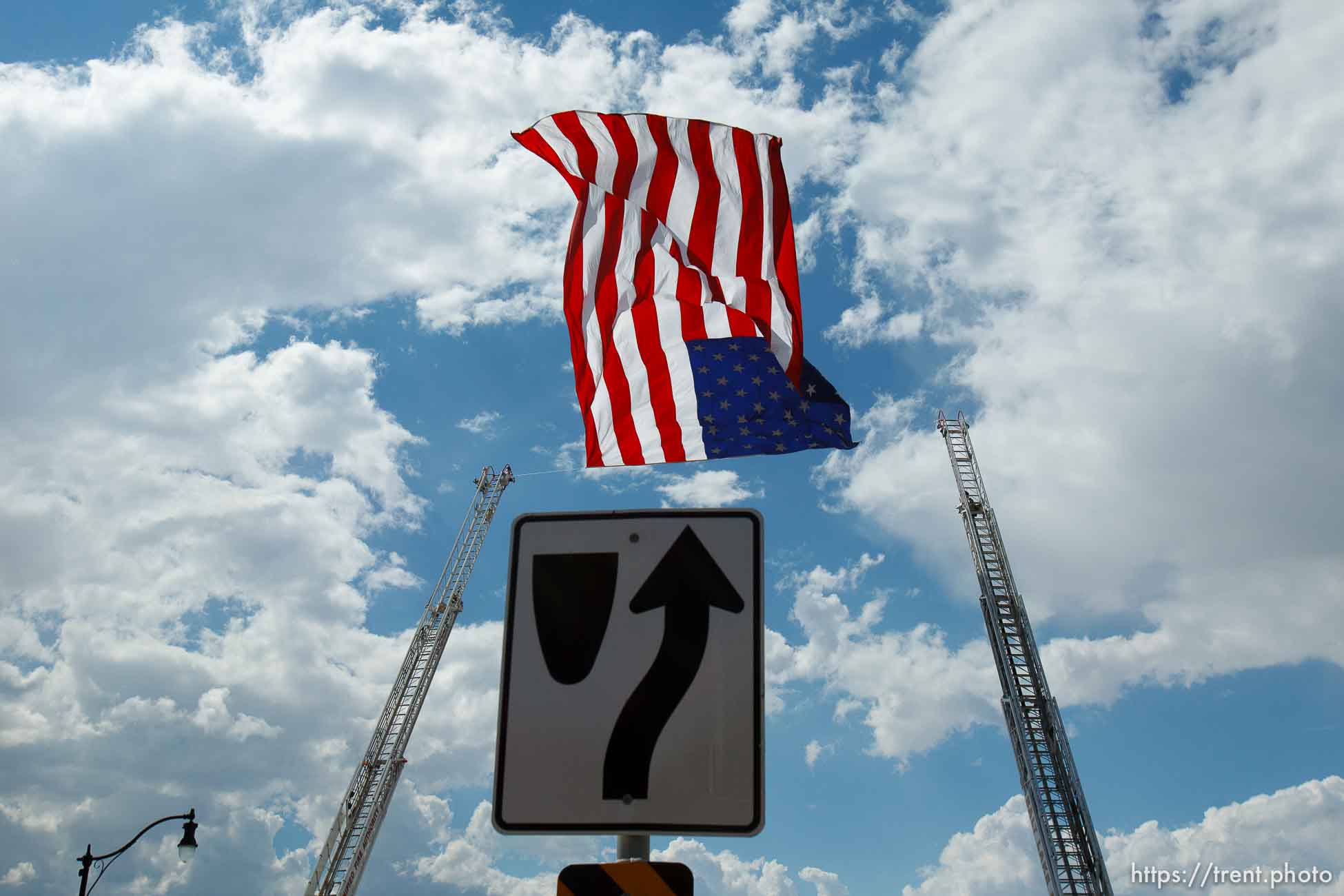 Trent Nelson  |  The Salt Lake Tribune
Flags fly as the funeral procession for Sgt. Derek Johnson, the Draper police officer who was shot to death on Sunday morning, passes through Draper Friday, September 6, 2013.