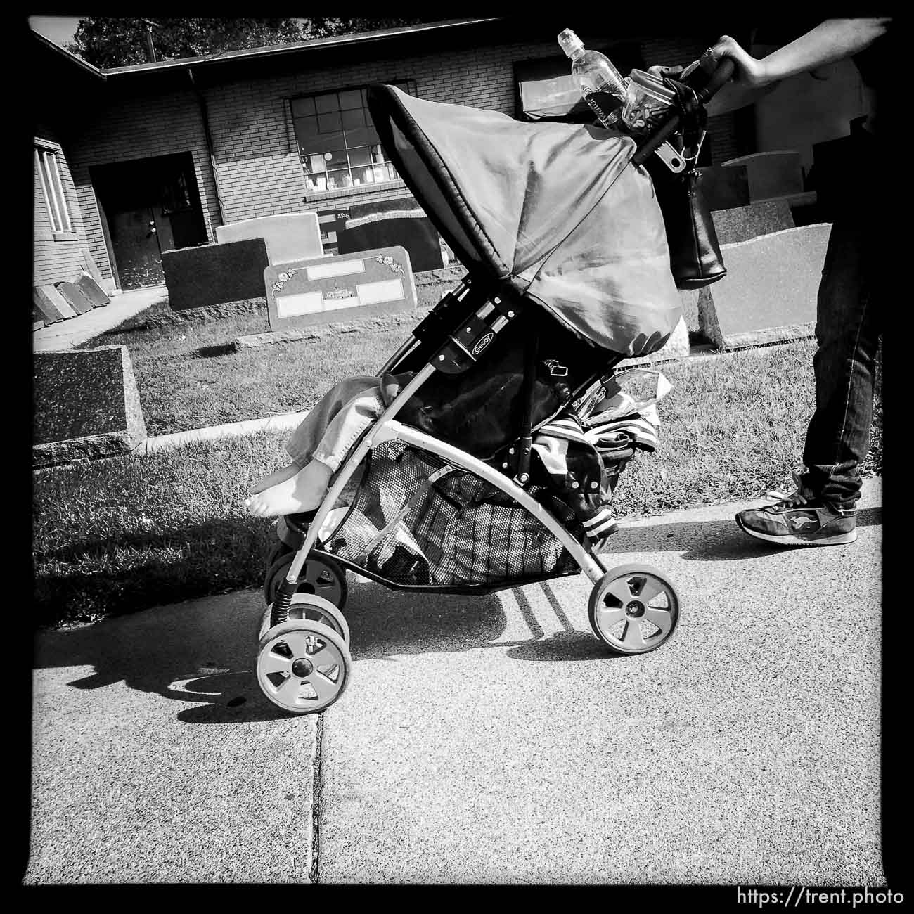 baby being walked past gravestones along State Street, Monday October 21, 2013.