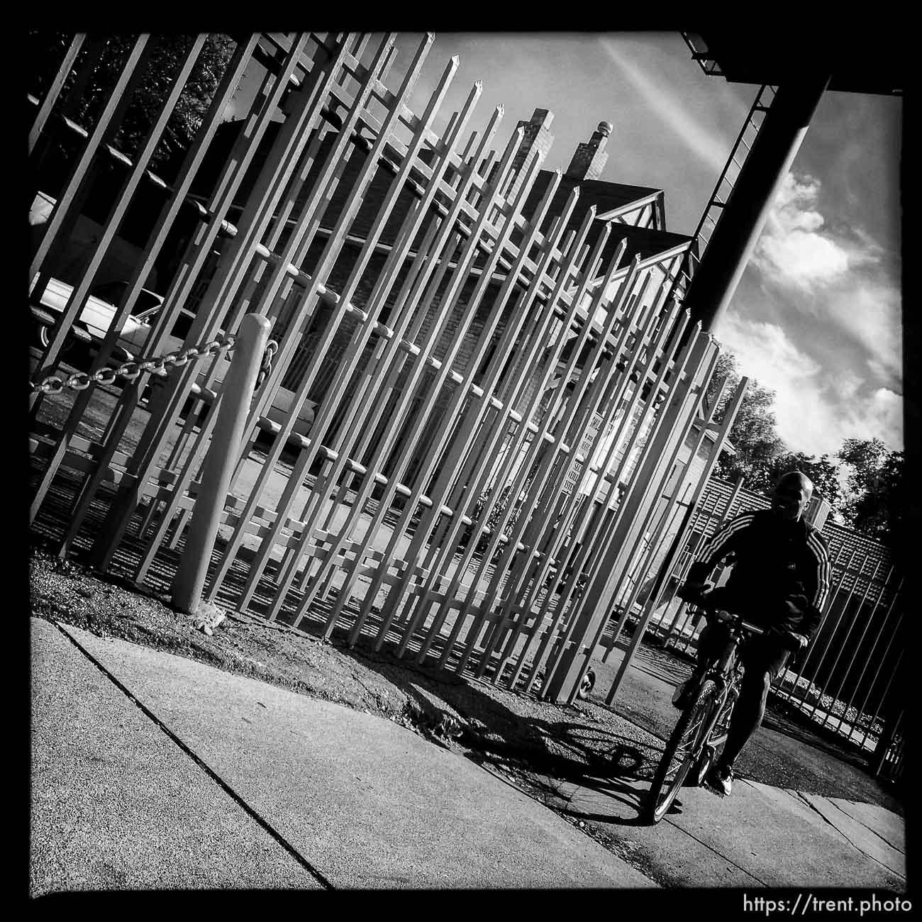 guy riding bike and fence, along State Street, Monday October 21, 2013.