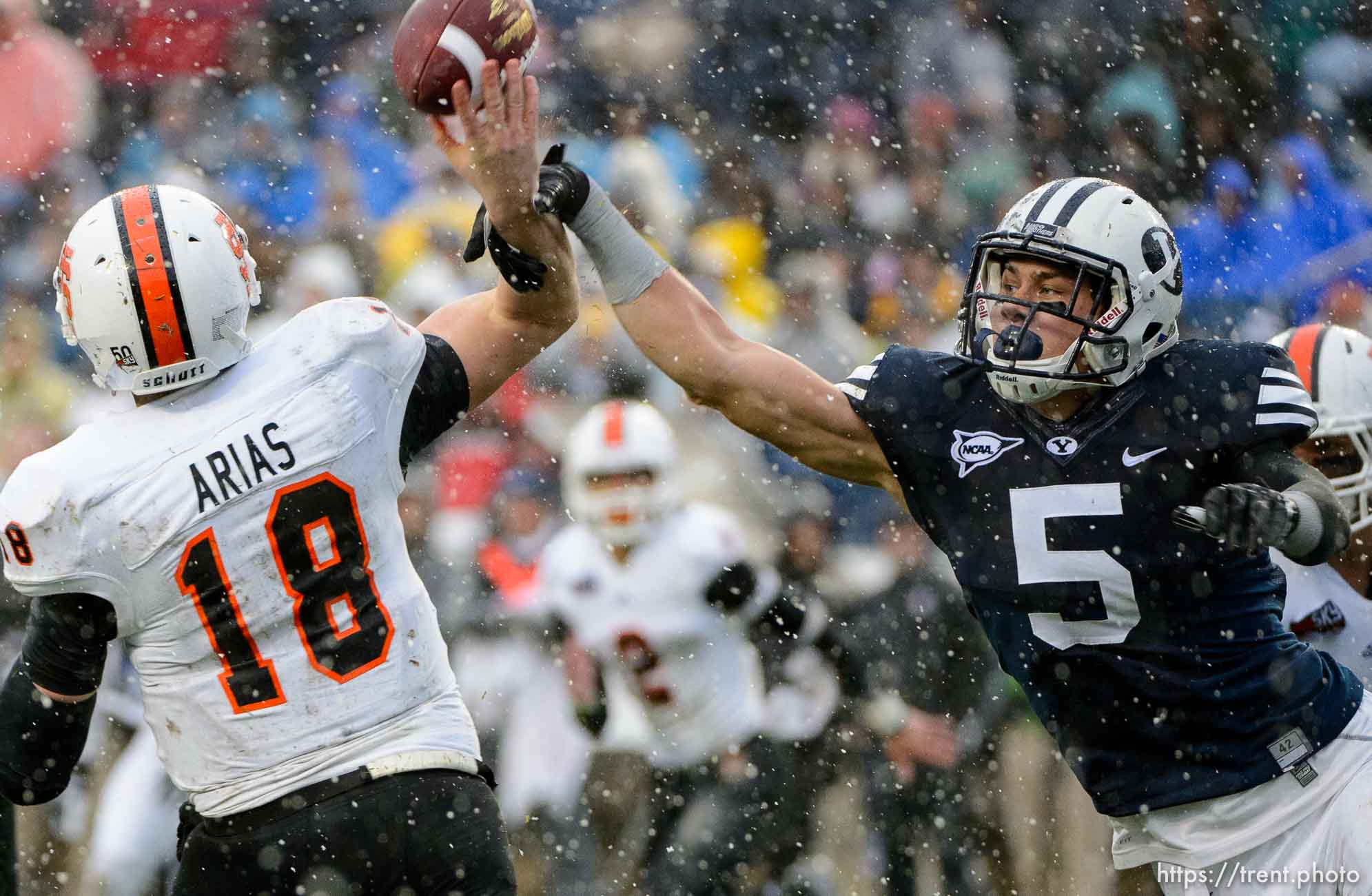 Trent Nelson  |  The Salt Lake Tribune
Brigham Young Cougars linebacker Alani Fua (5) gets a hand on a pass by Idaho State Bengals quarterback Justin Arias (18), which was returned for a touchdown by Brigham Young Cougars defensive lineman Bronson Kaufusi (90) as BYU hosts Idaho State, college football at LaVell Edwards Stadium in Provo, Saturday November 16, 2013.