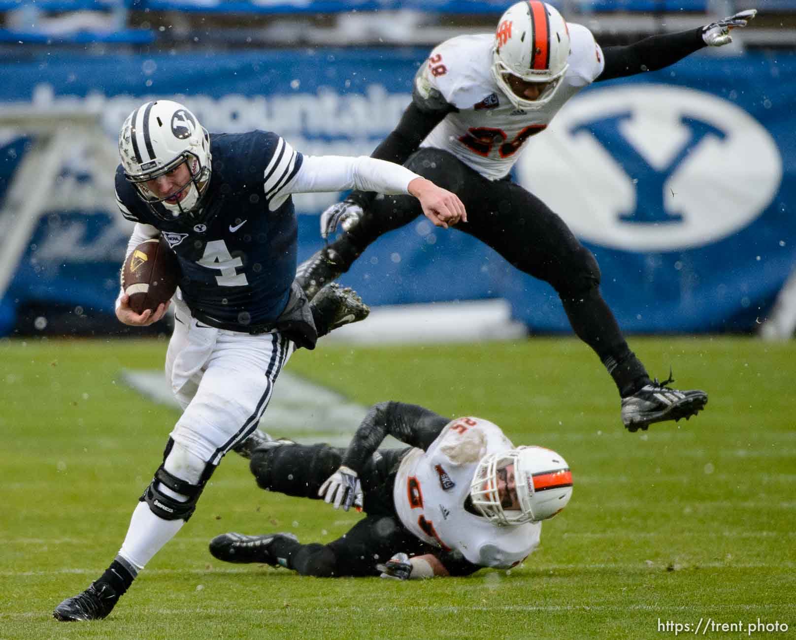 Trent Nelson  |  The Salt Lake Tribune
Brigham Young Cougars quarterback Taysom Hill (4) runs the ball as BYU hosts Idaho State, college football at LaVell Edwards Stadium in Provo, Saturday November 16, 2013. Idaho State Bengals defensive back Tanner Davis (25) and defensive back Cameron Gupton (28) at rear.