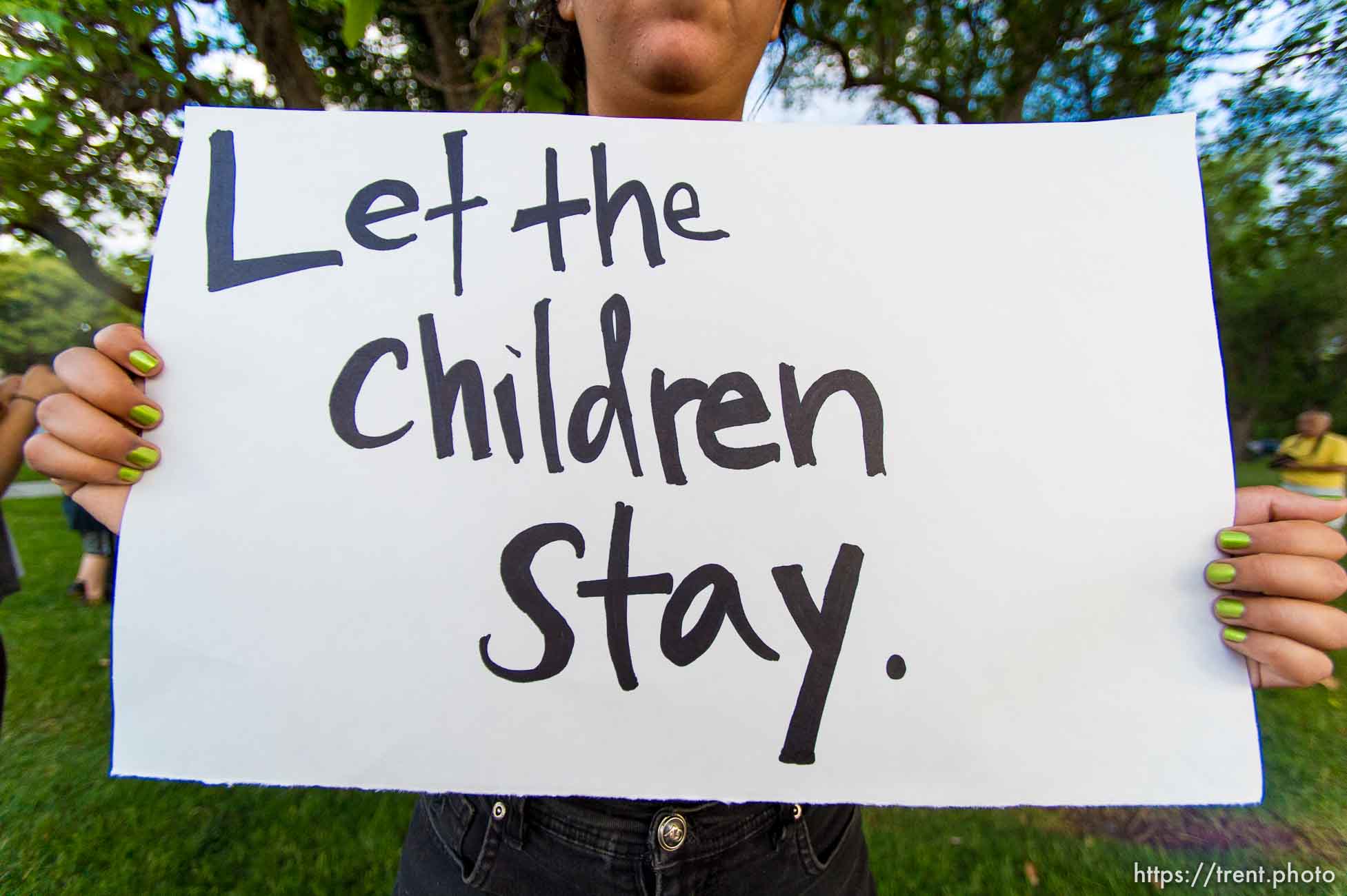 Trent Nelson  |  The Salt Lake Tribune
Iliana Correa holds a sign at a vigil in Liberty Park in Salt Lake City, Wednesday July 9, 2014. The vigil was against any deportation of unaccompanied migrant children being held in large numbers at the border.