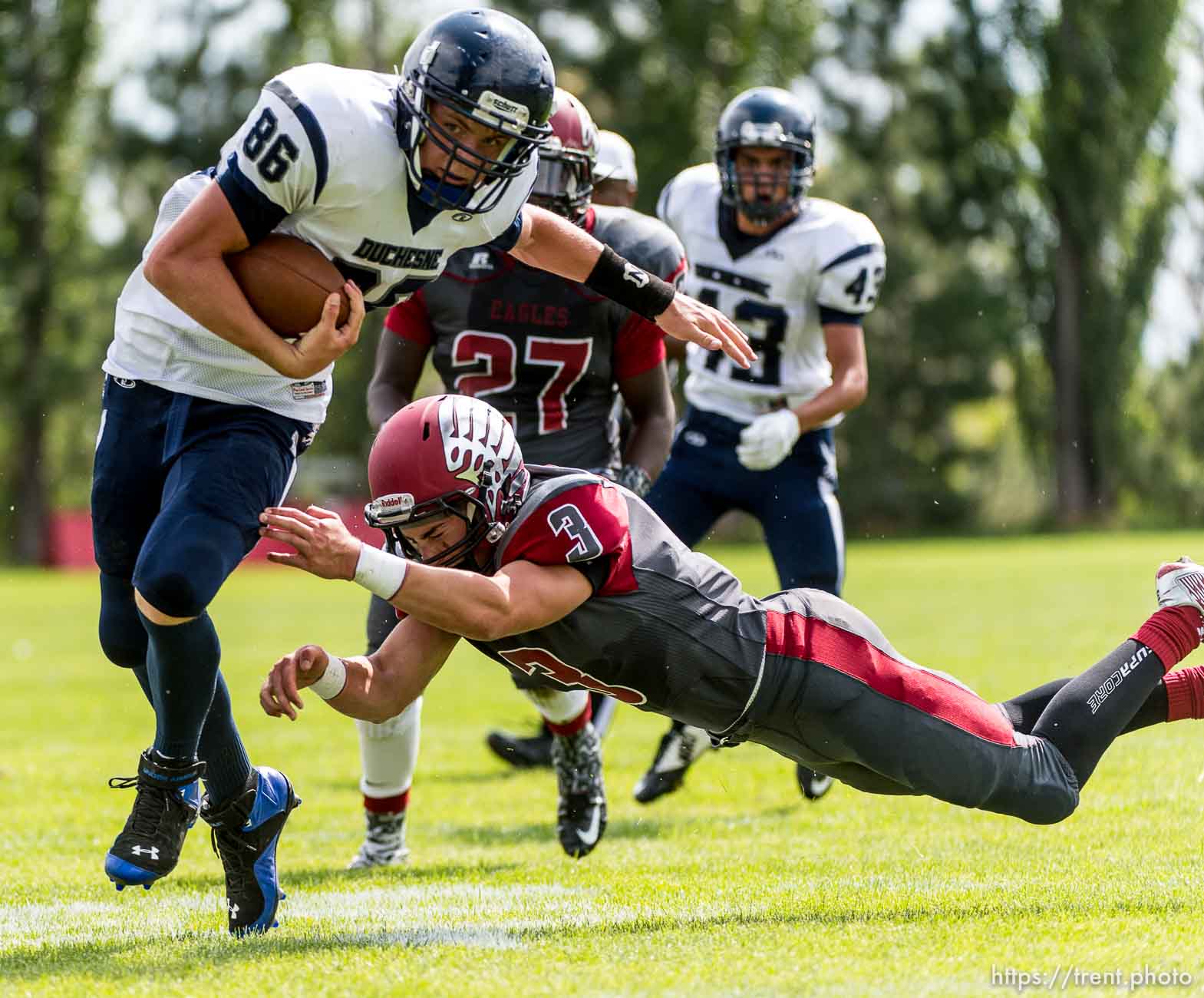 Trent Nelson  |  The Salt Lake Tribune
Duchesne's Wyatt Remund dodges Layton Christian's Bailey Kenter en route to scoring the first touchdown of the Utah high school football season, in Layton Thursday August 21, 2014.