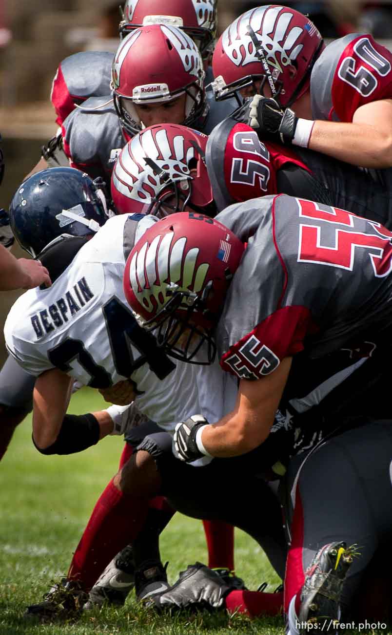 Trent Nelson  |  The Salt Lake Tribune
Layton Christian defenders bring down Duchesne's Dylan Despain, high school football in Layton Thursday August 21, 2014.