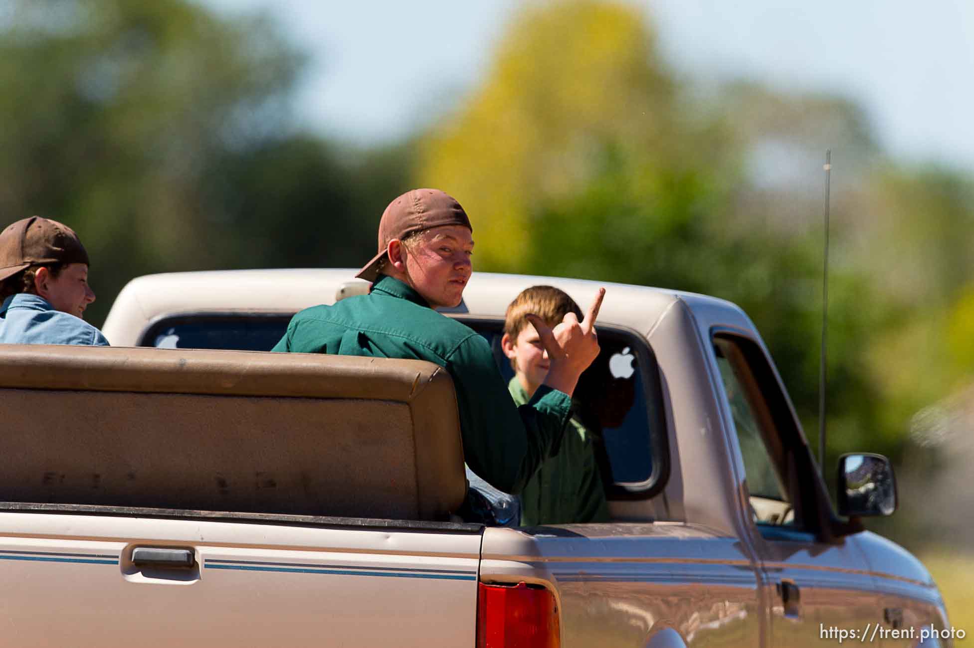 Trent Nelson  |  The Salt Lake Tribune
A candid reaction to a photographer, from a young man in the back of a passing truck in Hildale, Thursday September 25, 2014.