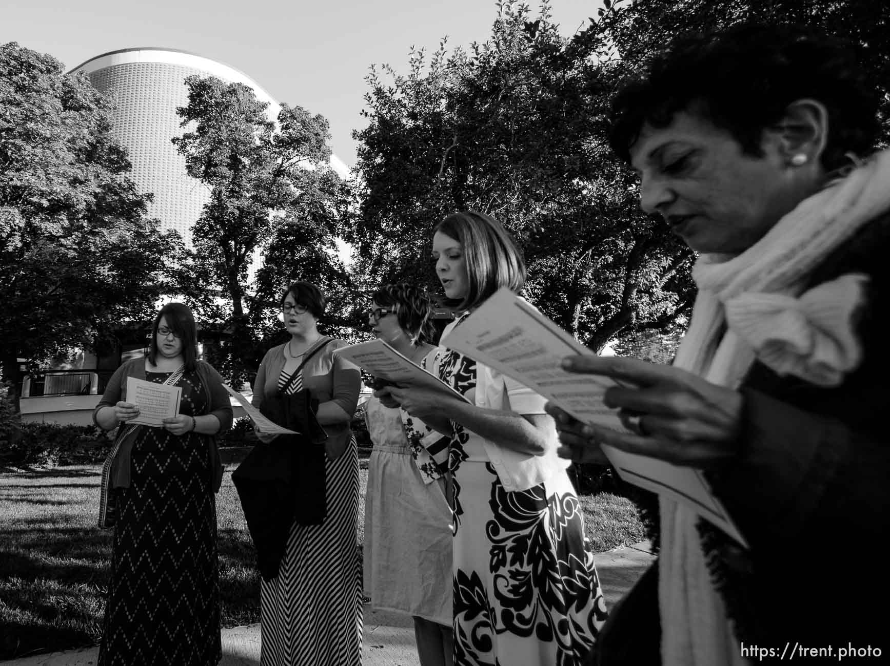 Trent Nelson  |  The Salt Lake Tribune
A group of people sing an LDS hymn before entering a broadcast of the LDS General Priesthood Session at BYU's Marriott Center in Provo Saturday October 4, 2014. The event was one of several planned by Ordain Women.