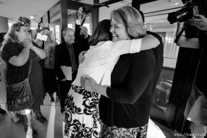 Trent Nelson  |  The Salt Lake Tribune
Abby Hansen, left, embraces Karen Roberts before leading a group of women through the door of BYU's Marriott Center to watch a broadcast of the LDS General Priesthood Session, in Provo Saturday October 4, 2014. Roberts and her husband Michael were volunteer ushers at the door assigned to meet the group and discourage, but not prevent the group from attending.