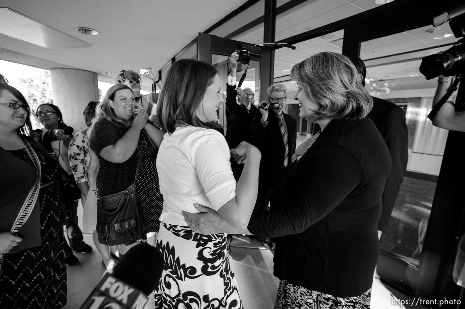 Trent Nelson  |  The Salt Lake Tribune
Abby Hansen, left, embraces Karen Roberts before leading a group of women through the door of BYU's Marriott Center to watch a broadcast of the LDS General Priesthood Session, in Provo Saturday October 4, 2014. Roberts and her husband Michael were volunteer ushers at the door assigned to meet the group and discourage, but not prevent the group from attending.